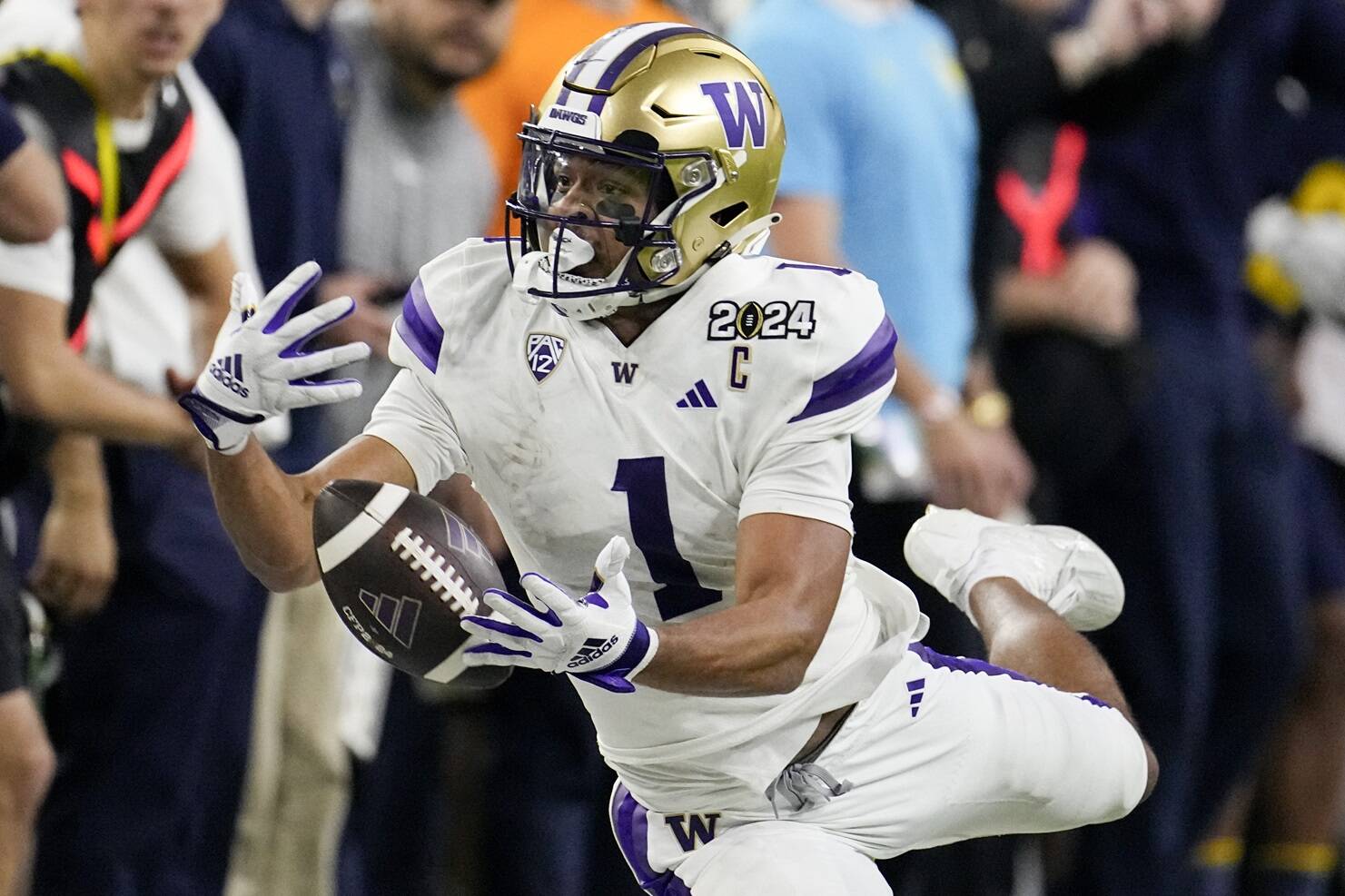 Washington wide receiver Rome Odunze can’t get a hold of a pass against Michigan during the second half of the national championship NCAA College Football Playoff game Monday, Jan. 8, 2024, in Houston. (AP Photo/David J. Phillip)
