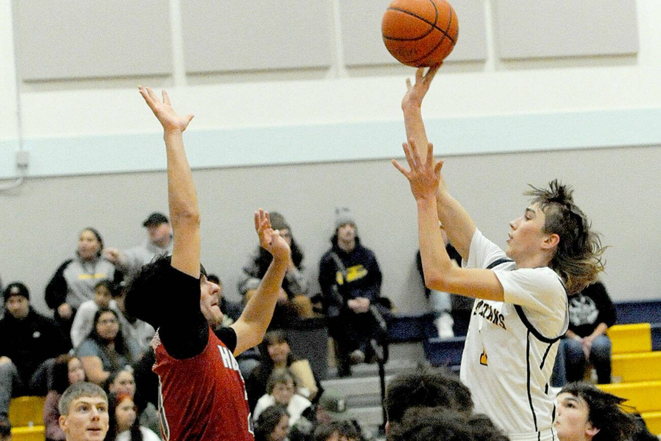 Forks’ Kyle Lohrengel scores over Hoquiam’s Chance LaBounty on Friday evening in a nonleague game in Forks. Also in action for Forks are Titus Rowley (20) and Landin Davis (5). (Lonnie Archibald/for Peninsula Daily News)
