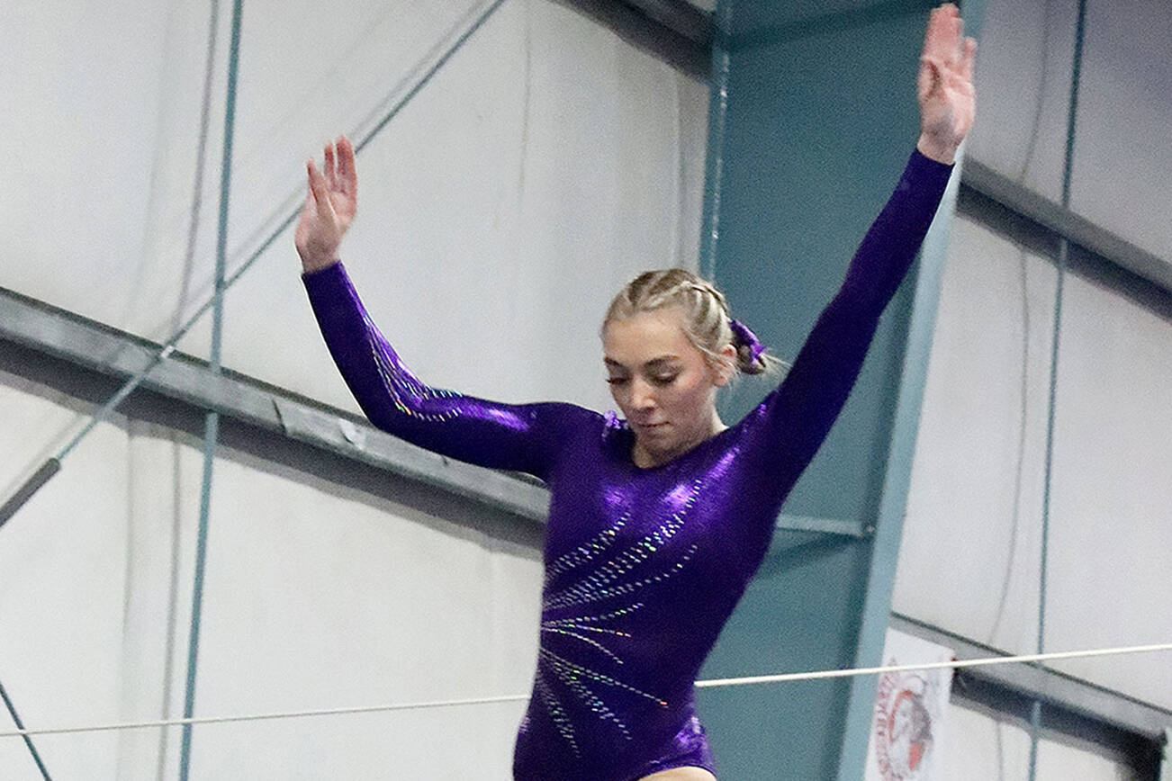 Susannah Sharp of Sequim, competing for the joint Port Angeles/Sequim gymnastics team, preforms on the balance beam Monday at a meet in Port Angeles against Bainbridge. Bainbridge edged Port Angeles/Sequim 164-139. (Dave Logan/for Peninsula Daily News)