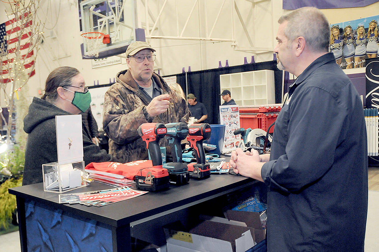 Jack and Marcella Ridge of Sequim talk about power tools with Tony Contestable, tool specialist with Hartnagel Building Supply of Port Angeles, right, during last year’s Building, Remodeling & Energy Expo in the Sequim High School gym. This year’s two-day event is scheduled for Saturday and Sunday. (Keith Thorpe/Peninsula Daily News)