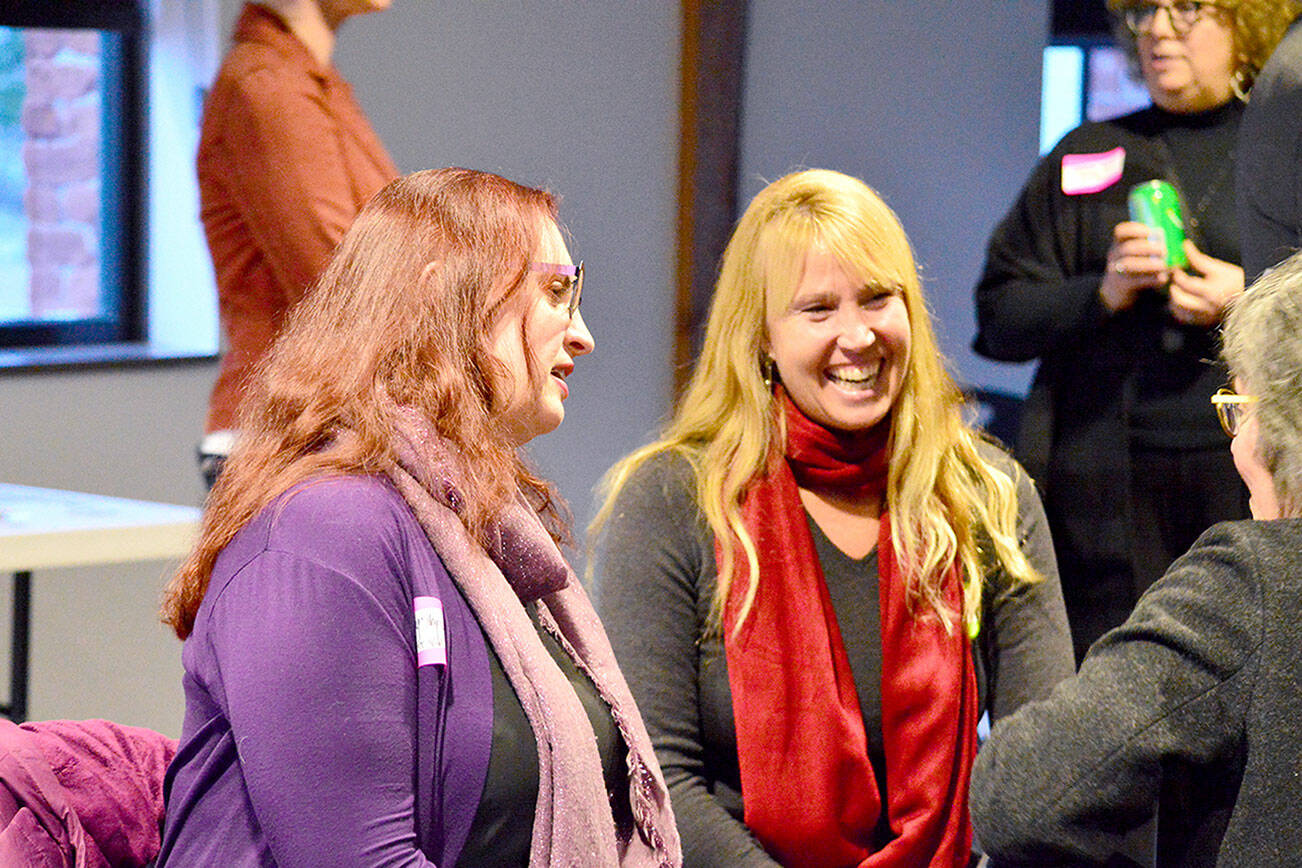 Port Townsend Library Director Melody Sky Weaver, left, and restaurateur Kris Nelson talked with community members at the Creative District plan unveiling Tuesday in Port Townsend. Diane Urbani de la Paz/For Peninsula Daily News