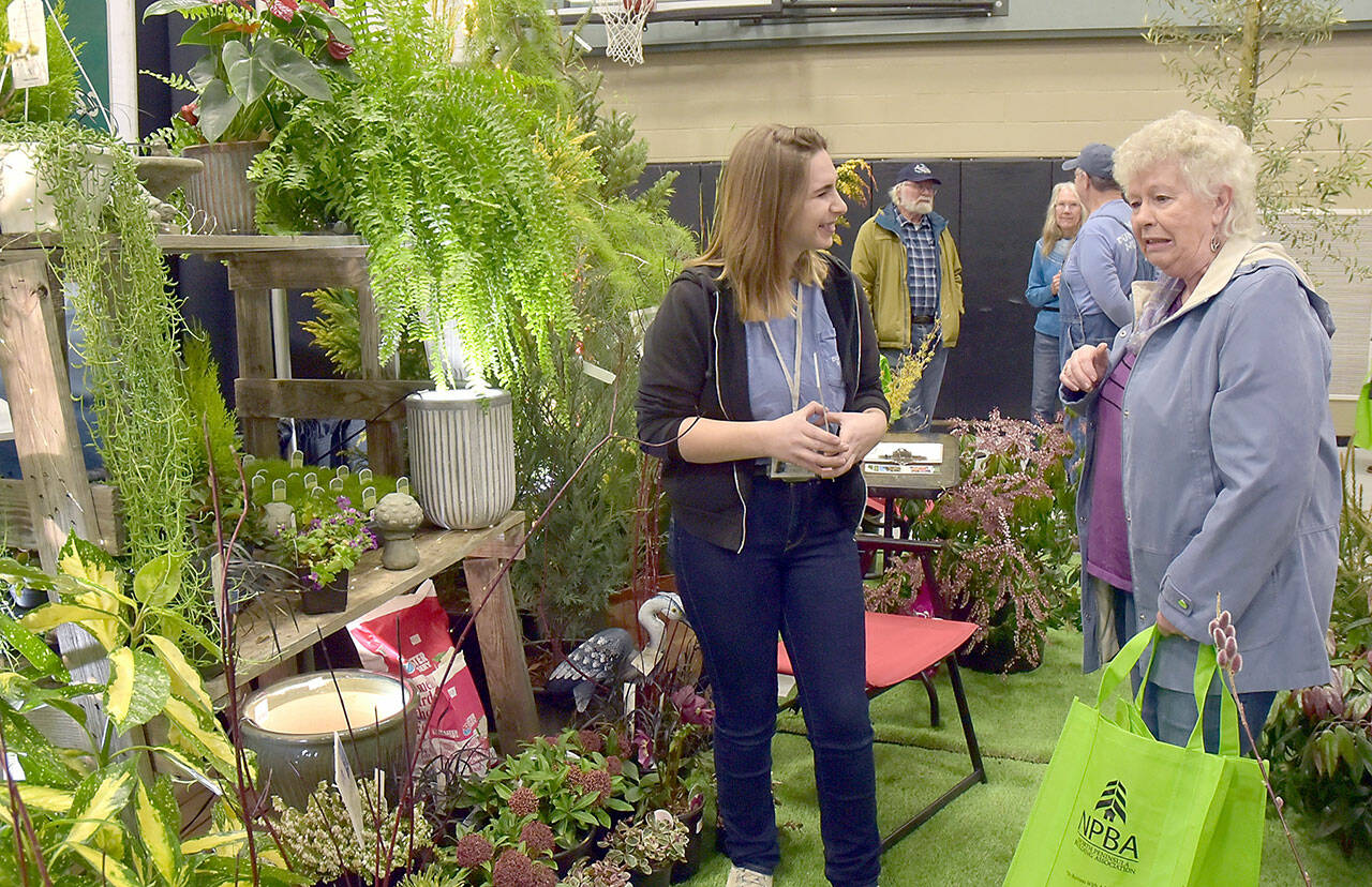 Dianne McIntosh of Sequim, right, chats about gardening with Jayde Carean, an employee of New Dungeness Nursery, during Saturday’s Building, Remodeling & Energy Expo at Sequim Middle School. The two-day event, hosted by the North Peninsula Building Association and sponsored by Clallam County PUD No. 1., featured displays, workshops and vendor booths showcasing a variety of building products and services. (Keith Thorpe/Peninsula Daily News)