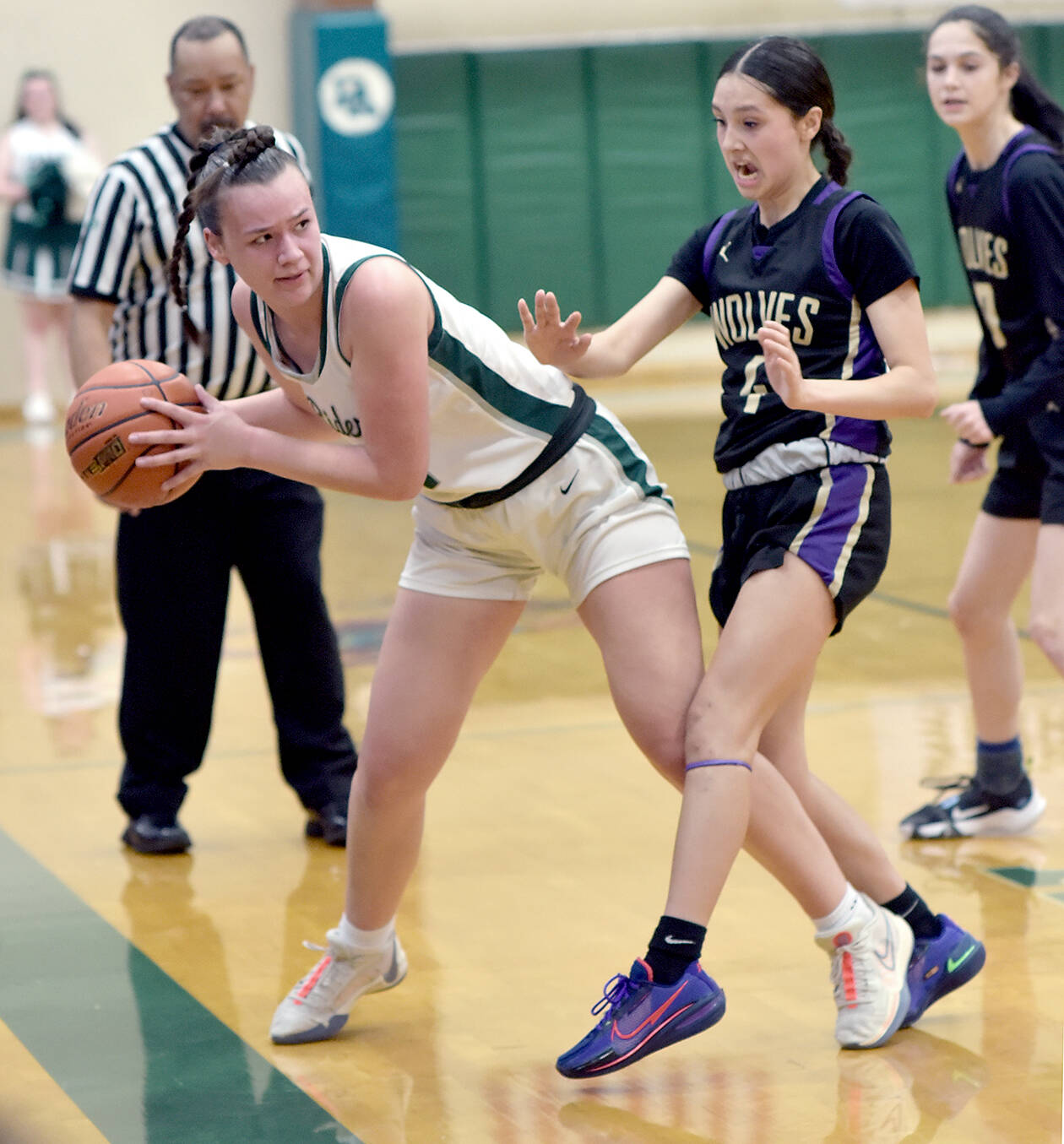 KEITH THORPE/PENINSULA DAILY NEWS
Port Angeles' Lexie Smith, left, leans out of bounds before passing past the defense of Sequim's Graciela Chartraw on Tuesday night in Port Angeles.