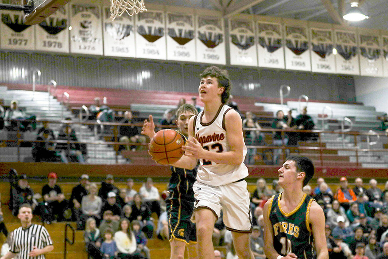 Napavine’s Cal Bullock, center, splits the defense of Forks’ Kyle Lohrengel and Dylan Micheau during a Class 2B Southwest District Tournament game at W.F. West High School in Chehalis. (Dylan Wilhelm/The Chronicle)