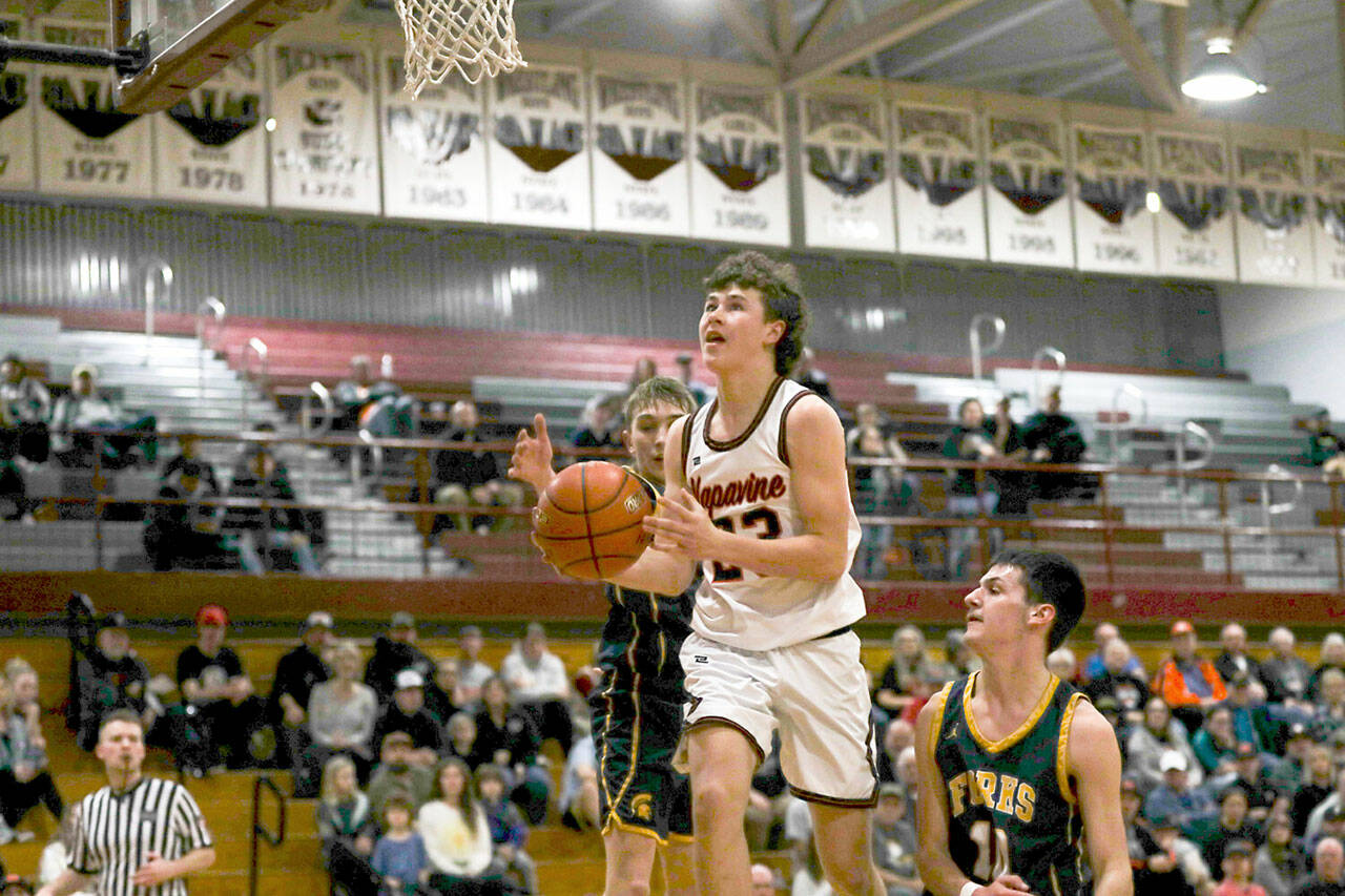 Napavine’s Cal Bullock, center, splits the defense of Forks’ Kyle Lohrengel and Dylan Micheau during a Class 2B Southwest District Tournament game at W.F. West High School in Chehalis. (Dylan Wilhelm/The Chronicle)