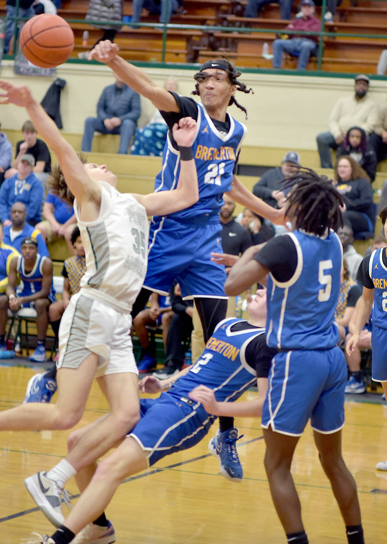 KEITH THORPE/PENINSULA DAILY NEWS Port Angeles’ Parker Nickerson, left, falls into his shot surrounded by Bremerton defenders, clockwise from top, Frank Allen, Enoch Taylor and Trenton Bulmer on Thursday night at Port Angeles High School.