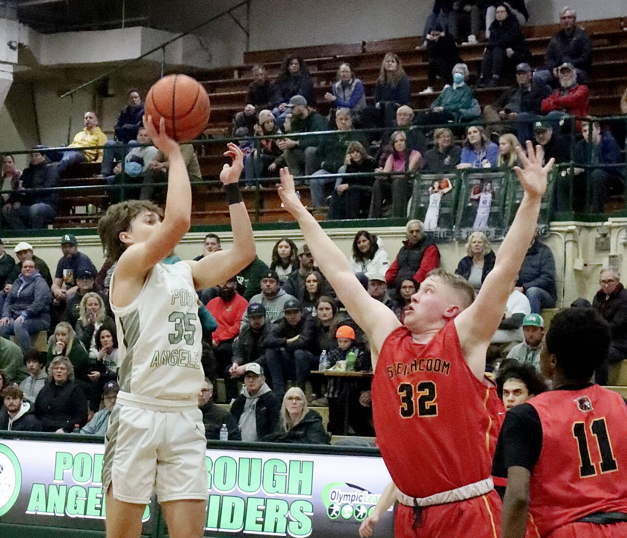 Port Angeles’ Parker Nickerson rises to shoot while defended by Steilacoom’s Chace McSherry during the Roughriders’ come-from-behind 63-49 bi-district tournament victory Thursday night. Port Angeles will face Enumclaw today in a winner-to-state, loser-out contest at 4 p.m. at Foster High School in Tukwila. (Dave Logan/for Peninsula Daily News)