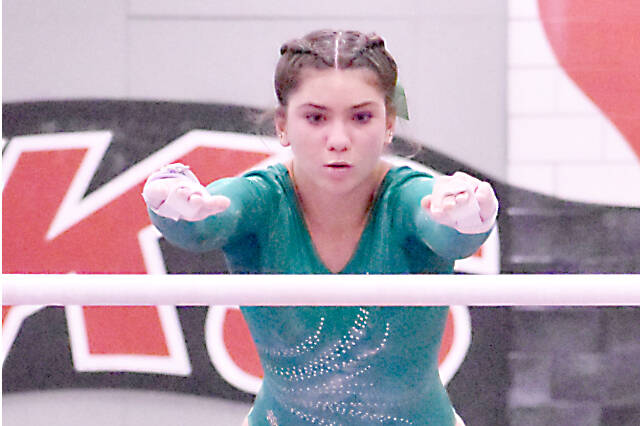 Scarlett Sullivan of Port Angeles competes in the bars at the state gymnastics meet at Sammamish High School. (Kevin Hanson/Enumclaw Courier-Herald)