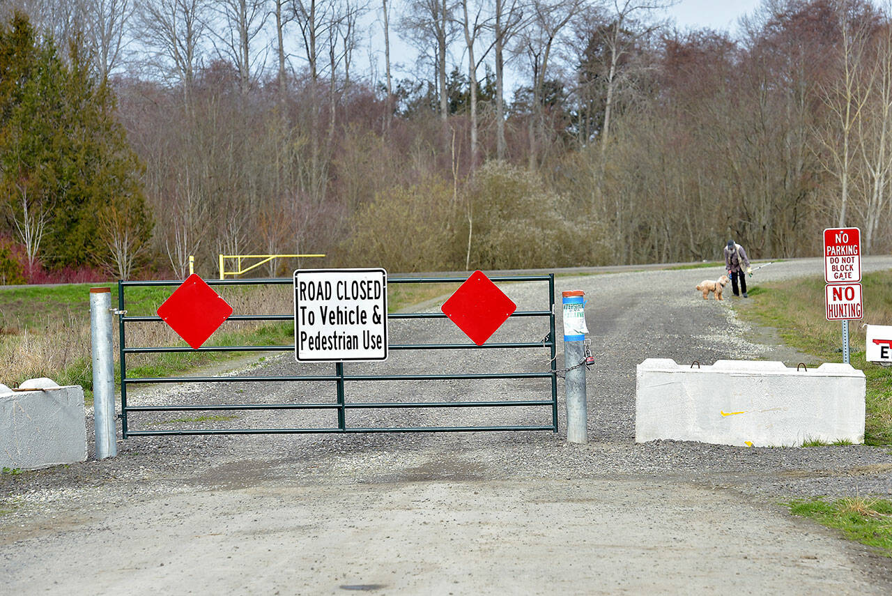 A gate and concrete barricades block the north end of Towne Road as it reaches the new Dungeness River levee on Tuesday northwest of Sequim. (Keith Thorpe/Peninsula Daily News)
