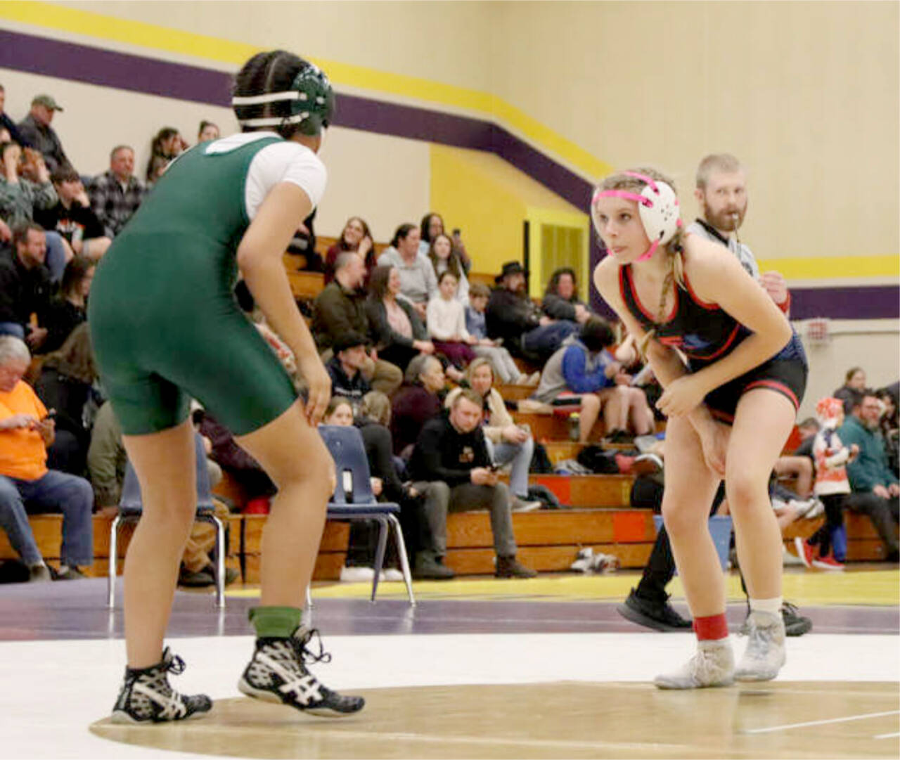 Chimacum seventh-grader Leighton Dunn stalks her opponent, Miles Hill of Port Angeles, at Blue Heron Middle School in Port Townsend last week. Dunn earned three takedowns only to fall in the second round in a pin. (Ryan White)
