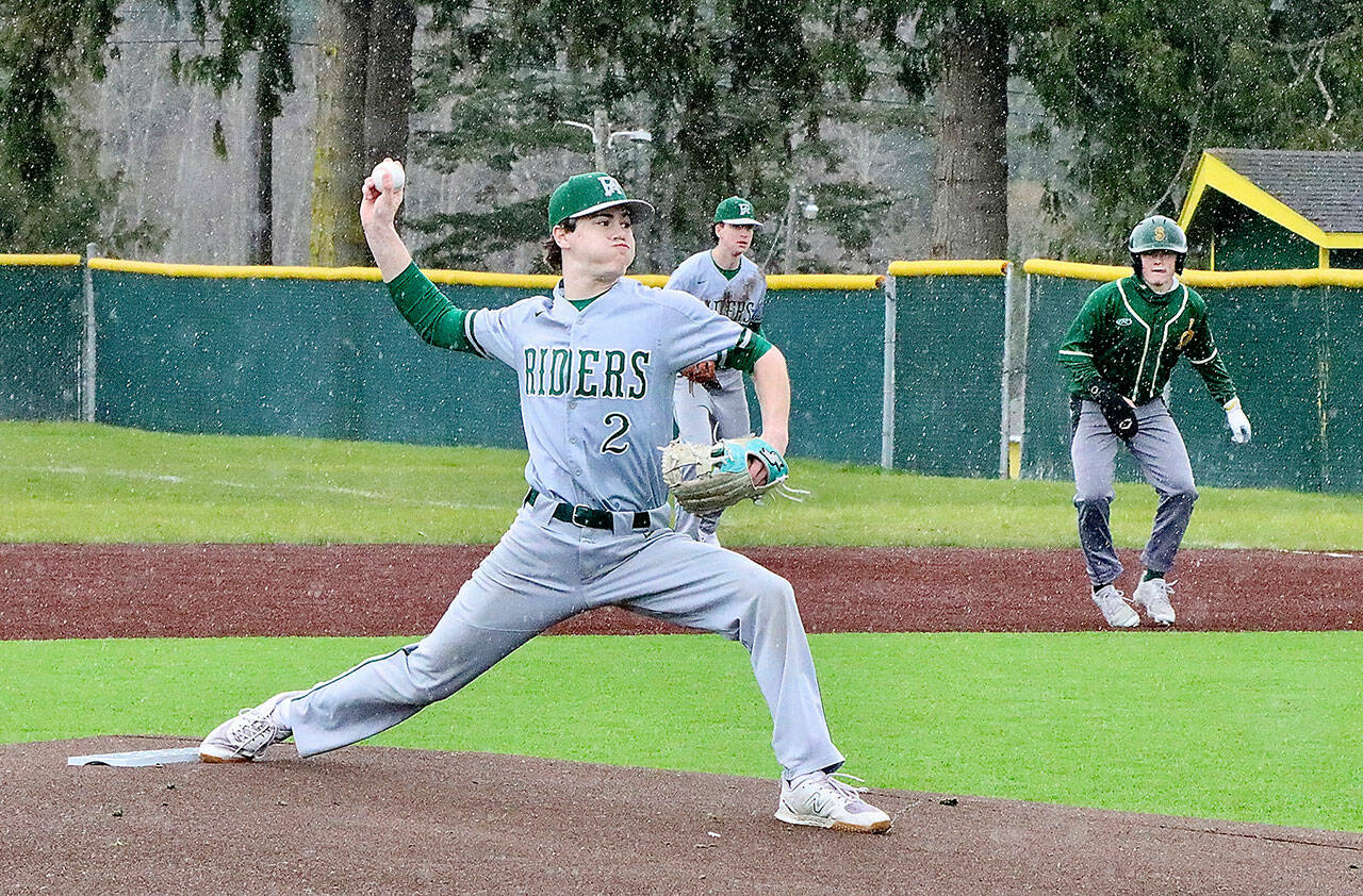Port Angeles starting pitcher Alex Angevine fires a pitch to home during the rainy game against Sehome at Volunteer Field on Saturday. (Dave Logan/for Peninsula Daily News)