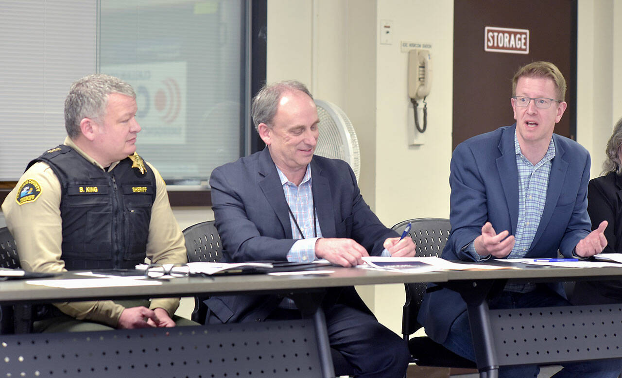 U.S. Rep. Derek Kilmer, right, discusses emergency services on Thursday during a roundtable session with emergency managers from across the region, including Clallam County Sheriff Brian King, left, and Clallam County Administrator Todd Mielke in Port Angeles. (Keith Thorpe/Peninsula Daily News)