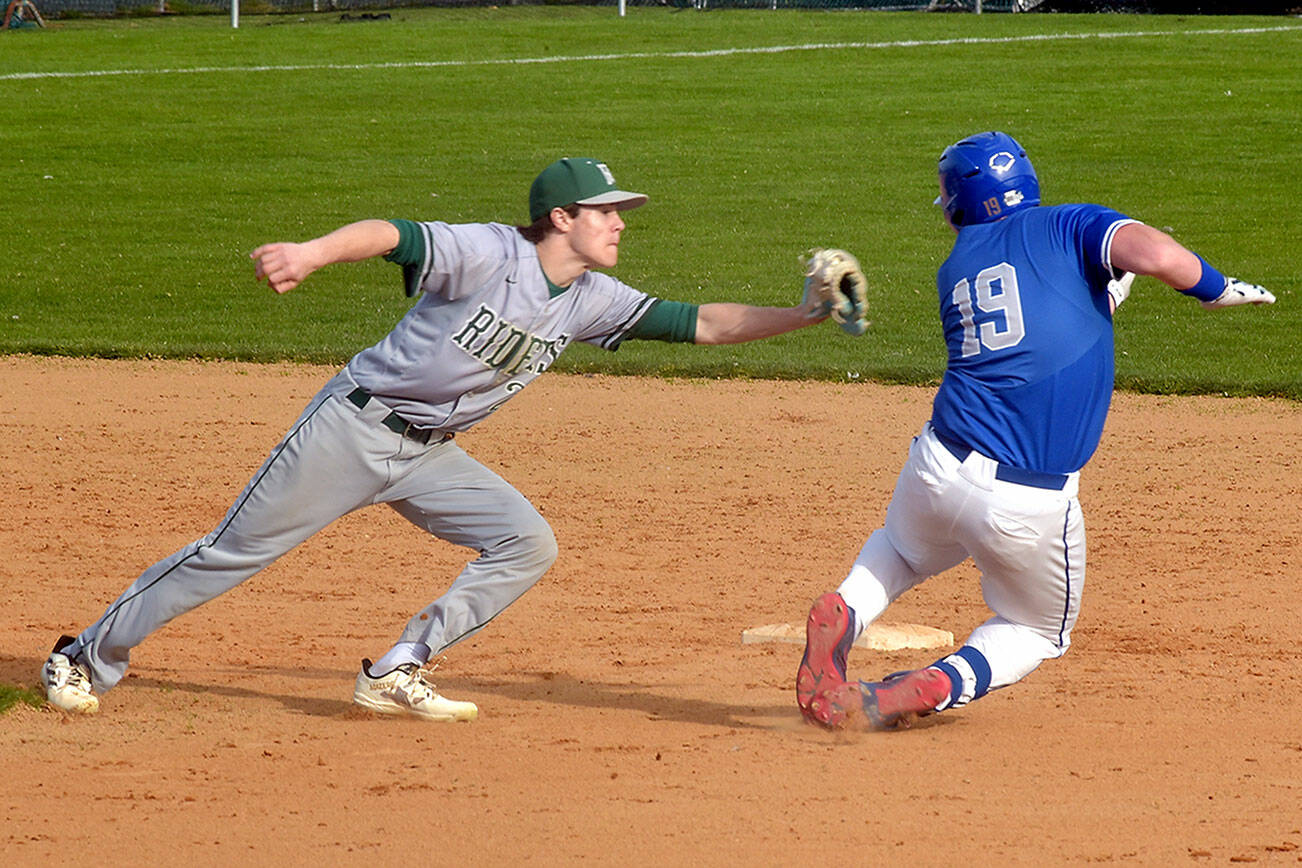 KEITH THORPE/PENINSULA DAILY NEWS
Port Angeles shortstop Alex Angevine, left, catches Olympic's Landon Nicholson on a second base steal attempt for an out during Thursday's game at Port Angeles Civic Field.