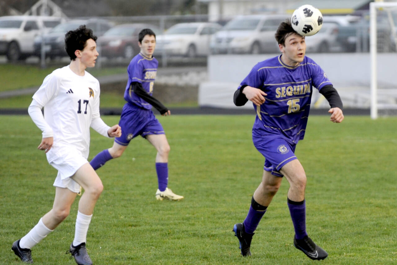 Sequim's Simon Hare (15) heads the ball against Bainbridge in Sequim on Tuesday. (Michael Dashiell/Olympic Peninsula News Group)