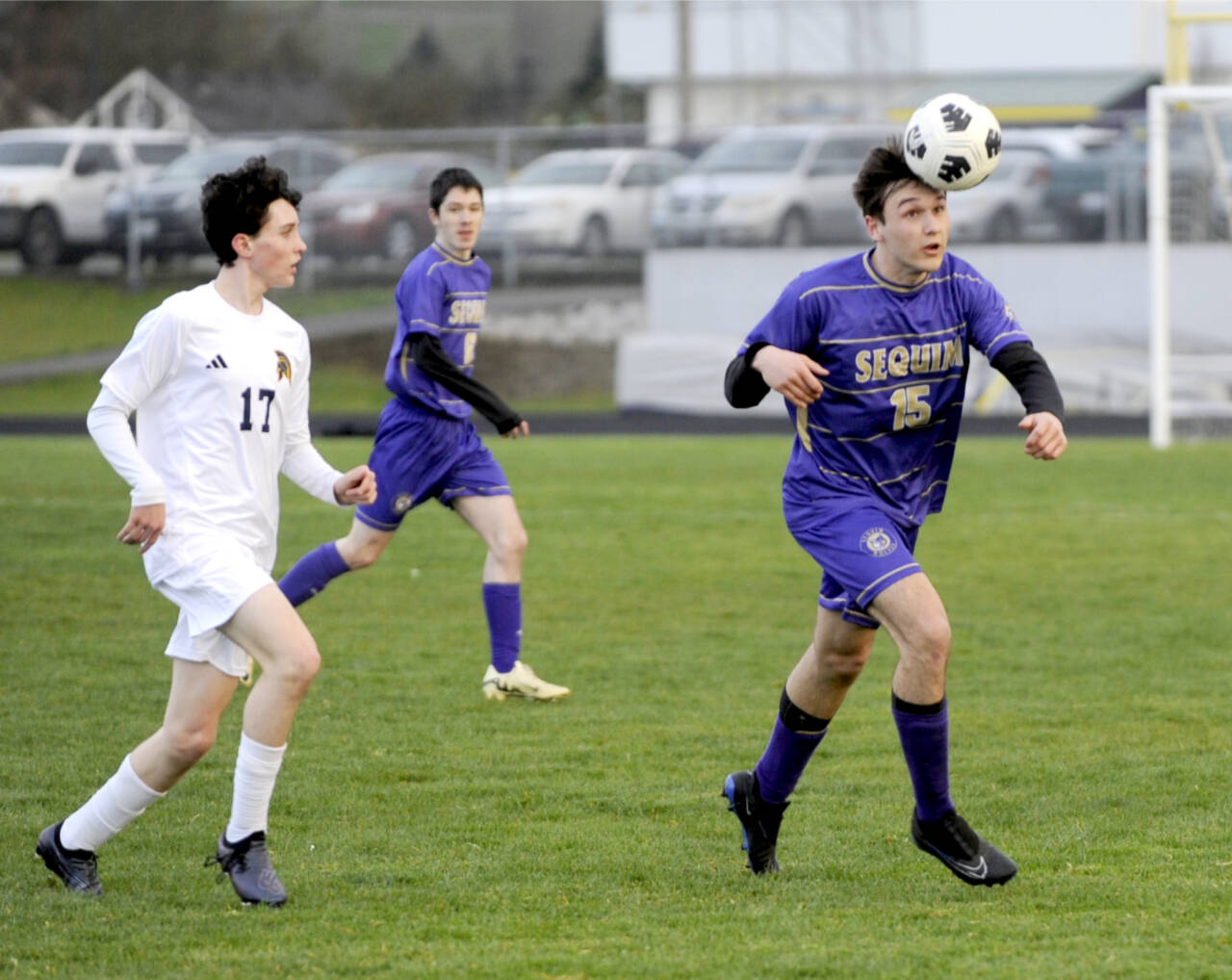 Sequim’s Simon Hare (15) heads the ball against Bainbridge in Sequim on Tuesday. (Michael Dashiell/Olympic Peninsula News Group)