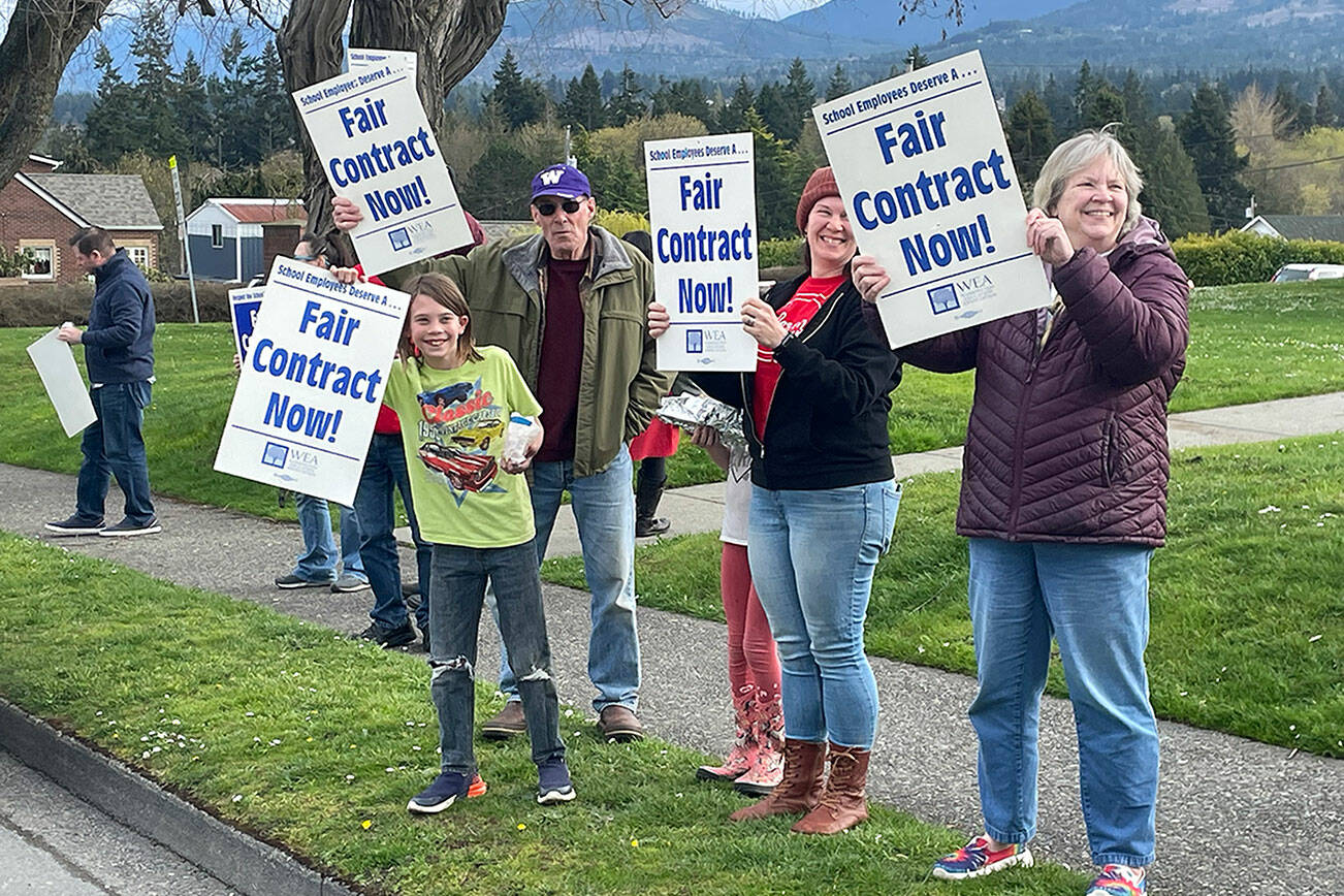 Supporters of paraeducators rally outside the Port Angeles School District administration headquarters at Lincoln Center on Thursday. The Port Angeles Paraeducators Association has voted to strike April 8 if an agreement with the PASD for a 3.7 percent wage increase can't be reached. (Paula Hunt/Peninsula Daily News)