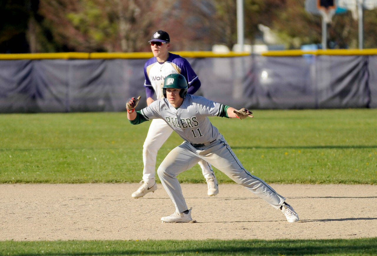 Port Angeles’ Josiah Gooding (11) leads off of second base while Sequim shortstop Devyn Dearinger plays behind him in Sequim on Friday. The Roughriders won 7-4. (Michael Dashiell/Olympic Peninsula News Group)