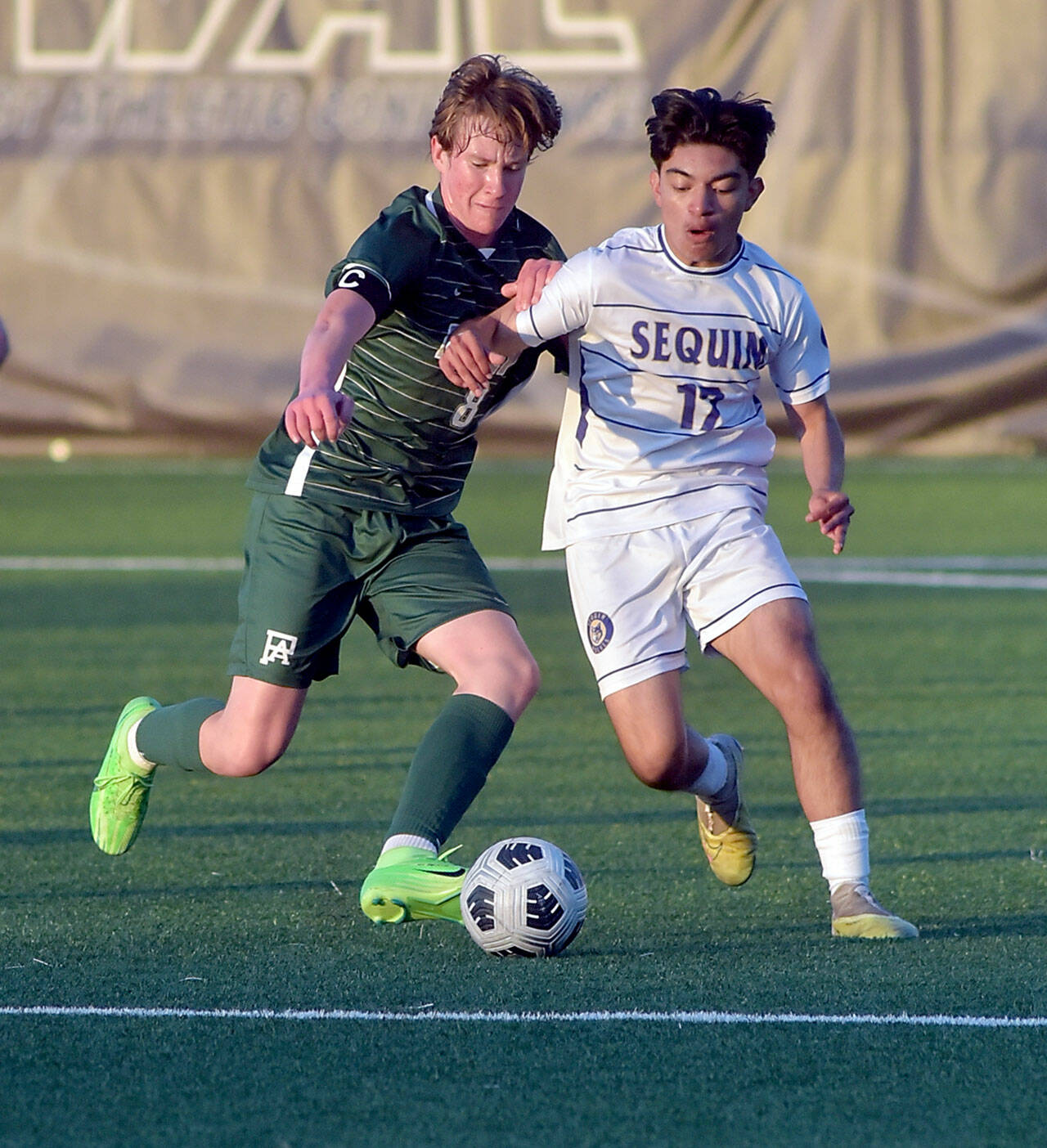 KEITH THORPE/PENINSULA DAILY NEWS Port Angeles’ Jacob Weaver, left, fights for ball control with Sequim’s Evan Cisneros on Tuesday at Peninsula College in Port Angeles.