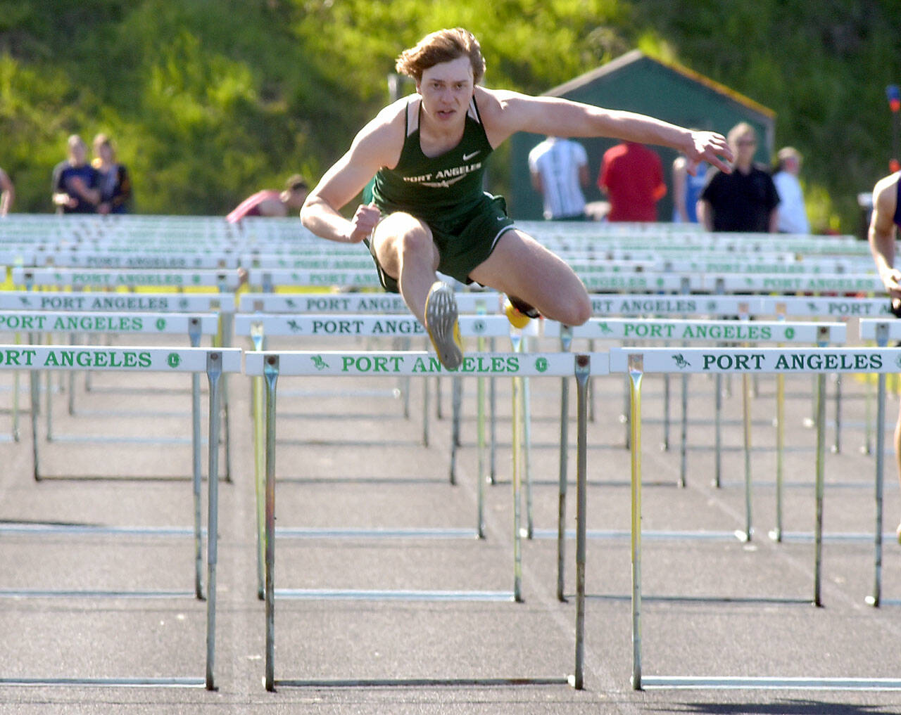 KEITH THORPE/PENINSULA DAILY NEWS Parker Nickerson of Port Angeles leads the way to win the boys 100 hurdles on April 19 on the track at Port Angeles High School.