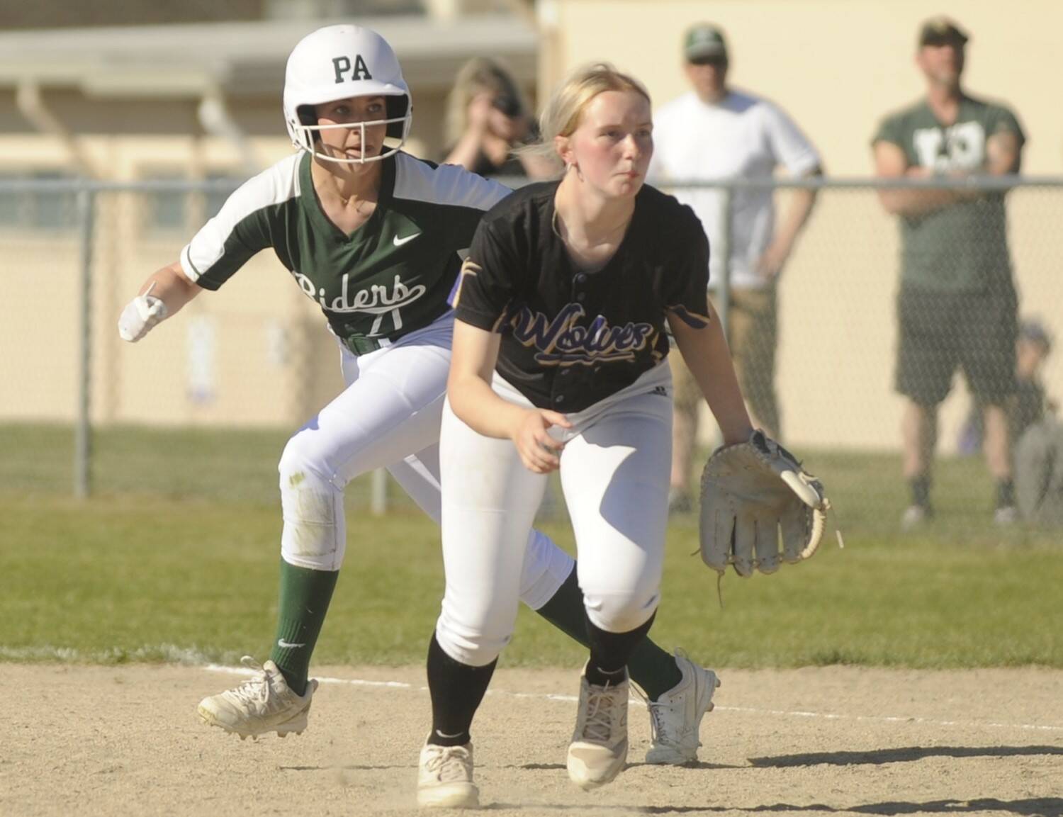 Port Angeles’ Ava-Anne Sheahan takes a lead off first base behind Sequim first baseman Ava Ritter on Friday in Sequim. (Michael Dashiell/Olympic Peninsula News Group)