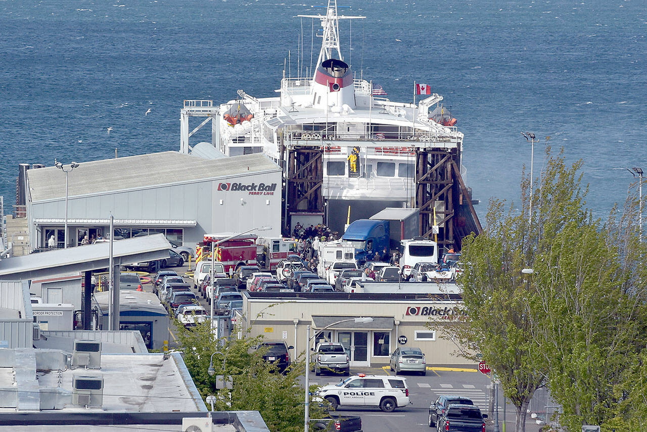 Smoke vents from the rear car deck doors as firefighters battle a vehicle fire aboard the ferry MV Coho upon its afternoon arrival in Port Angeles on Thursday. (Keith Thorpe/Peninsula Daily News)
