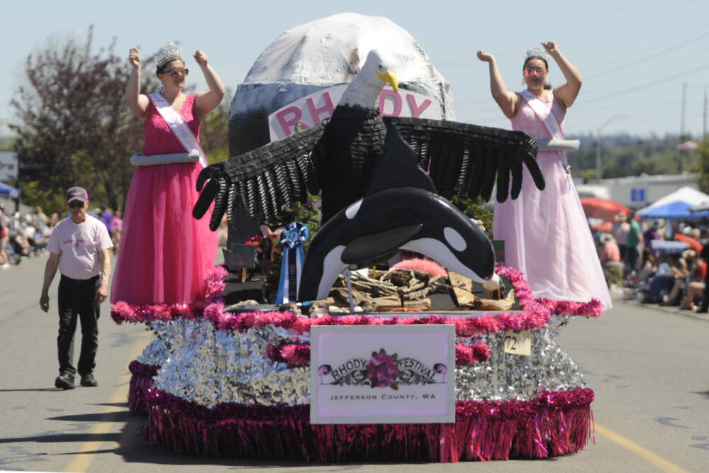 This year's Rhododendron Festival queen Paige Govia and princess Rosie Schmucker wave to the Sequim Irrigation Festival Grand Parade crowd on May 11. (Michael Dashiell/Olympic Peninsula News Group)