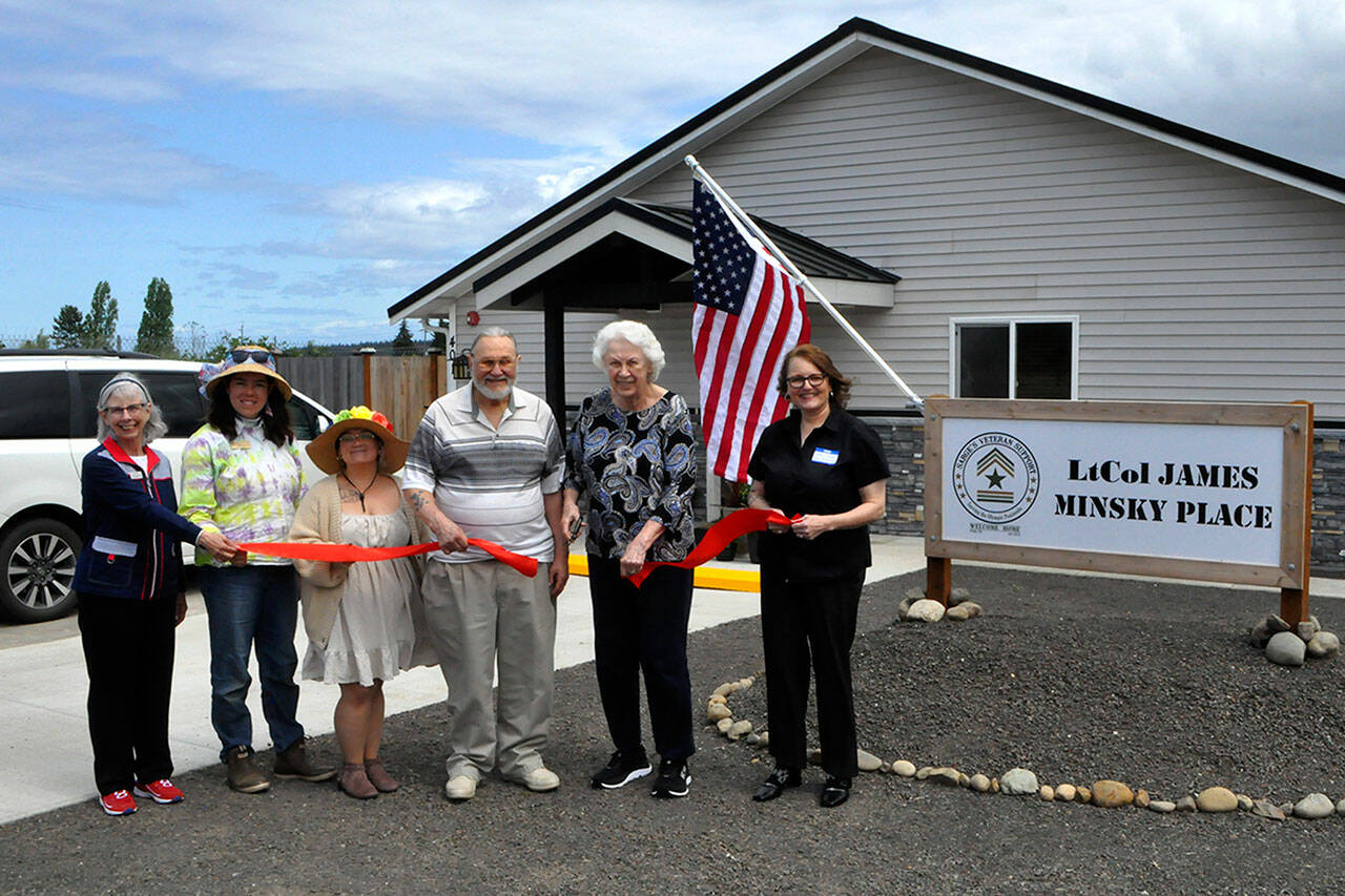 Helen and Greg Starr, executors of James Minsky’s estate, cut the ribbon for LtCol James Minsky Place on May 17 with Cheri Tinker, executive director of Sarge’s Veteran Support, right, and Sarge’s board president Lorri Gilchrist, and city council members Harmony Rutter and Rachel Anderson. The facility will permanently house six disabled and/or elderly veterans in Sequim. (Matthew Nash/Olympic Peninsula News Group)