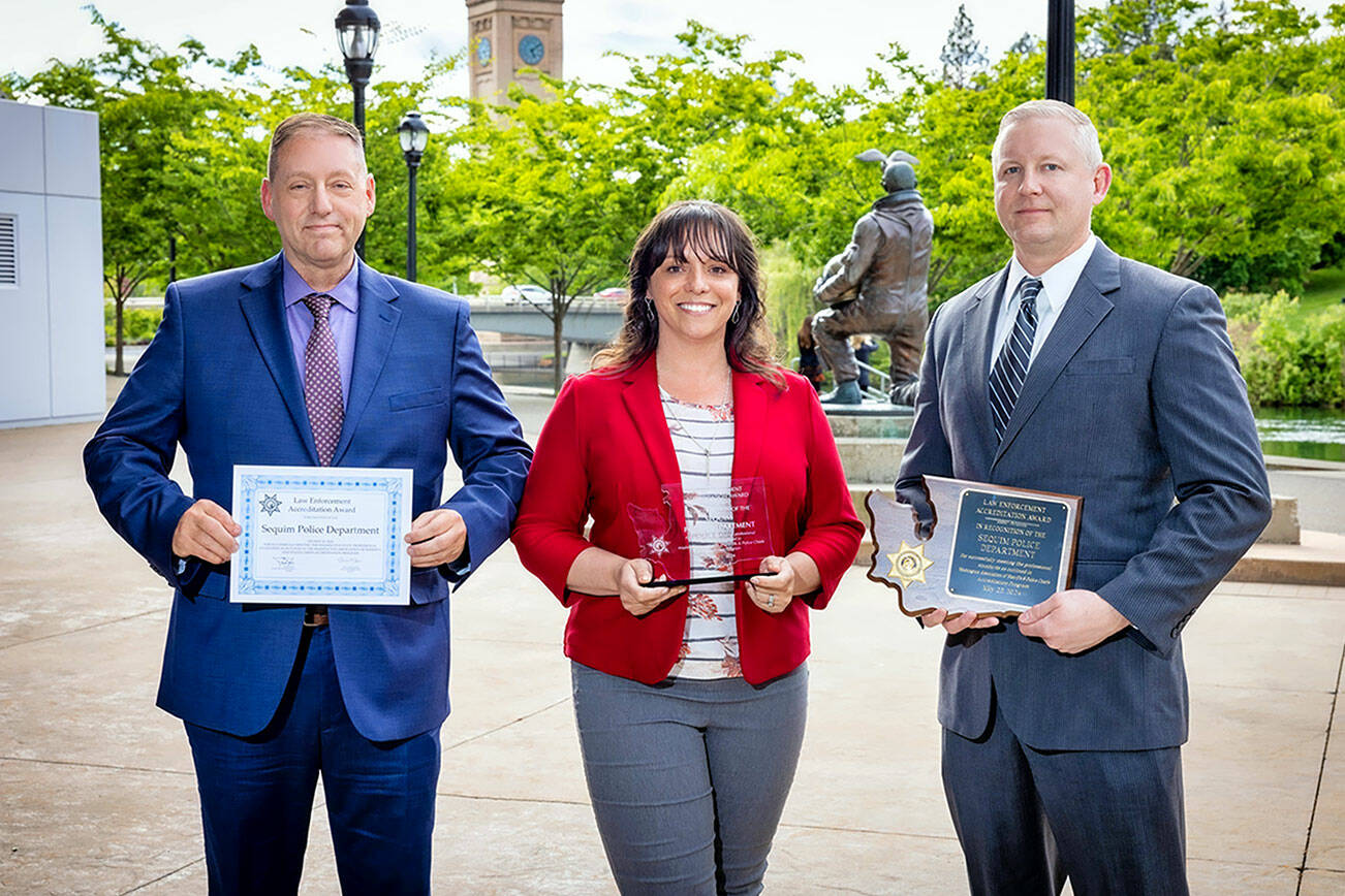 From left, Sequim Deputy Police Chief John Southard, Tiffany Banning and Police Chief Mike Hill received renewed accreditation recognition from the Washington Association of Sheriffs and Police Chiefs.