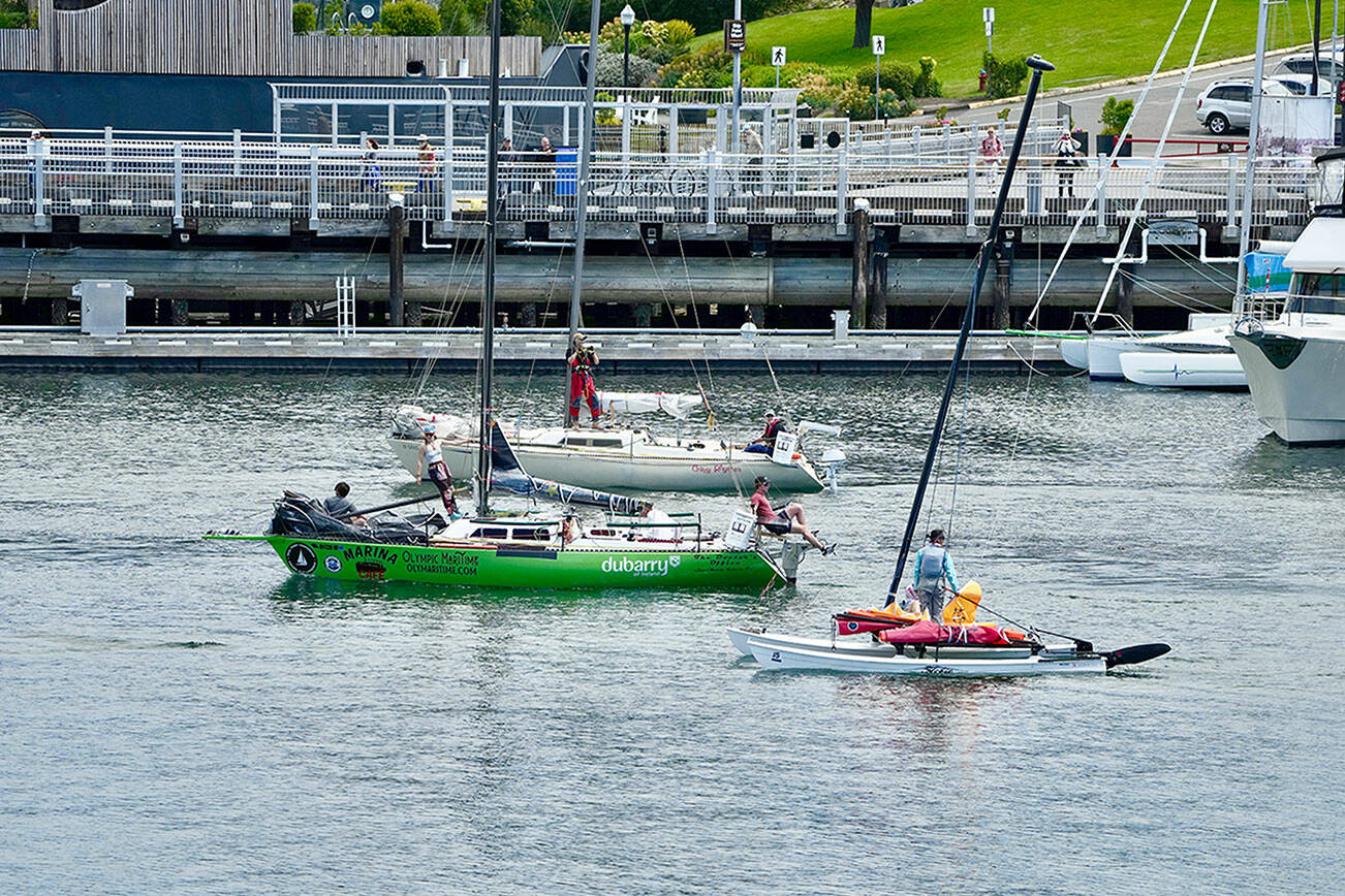 Team Roscoe Pickle Train of Port Townsend, which includes Chris Iruz, Enzo Dougherty, Odin Smith and Pearl Smith, were first out of the Victoria Inner Harbour at the start of the Race to Alaska on Tuesday. The cannon fired at noon and 38 racers headed to Ketchikan, a 750-mile contest that started in Port Townsend on Sunday. (Steve Mullensky/for Peninsula Daily News)