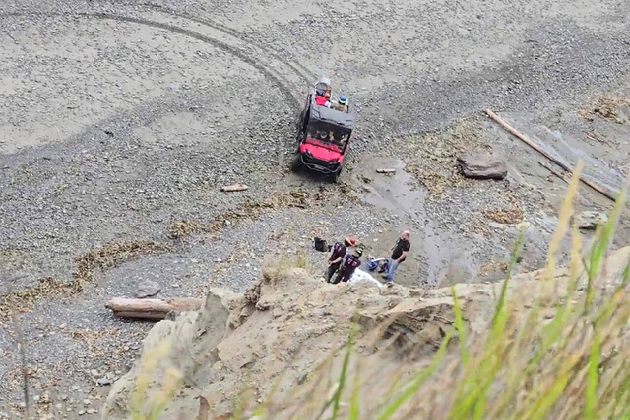Firefighters rappelled down bluffs north of Sequim overlooking the Strait of Juan de Fuca to help a woman who was hurt while looking for her dog that fell. (John McKenzie)
