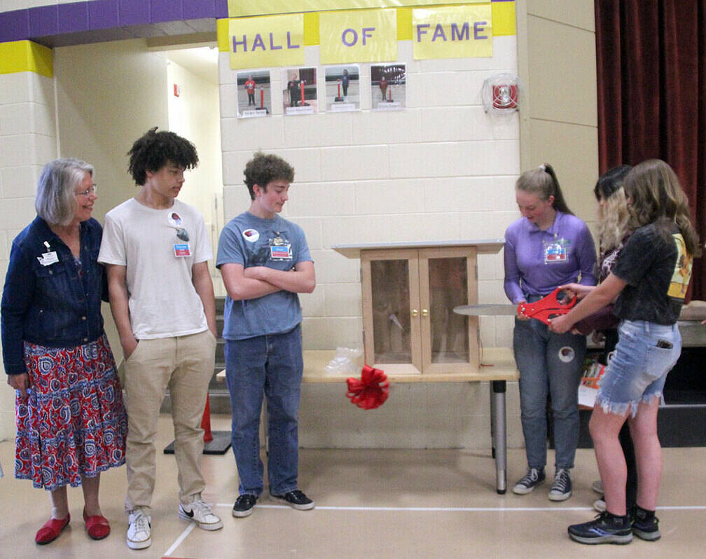 Pictured left to right, Ginny Wagner, Xxzavyon (XJ) Square, Ewan Mordecai-Smith, Elise Sirguy, Mahayla Amendolare and Mallory Hartman cut the ribbon of the little free library at Jefferson Elementary School on Friday. (Darlene Cook)