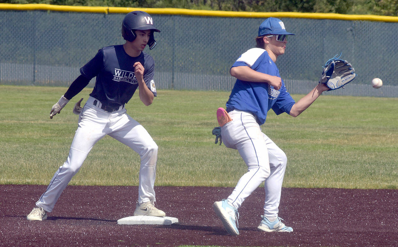 KEITH THORPE/PENINSULA DAILY NEWS Wilder Junior’s Bryce Deleon, left, arrives at second ahead of the throw to Sedro-Woolley shortstop Cail Wilson on Tuesday afternoon at Port Angeles Volunteer Field.