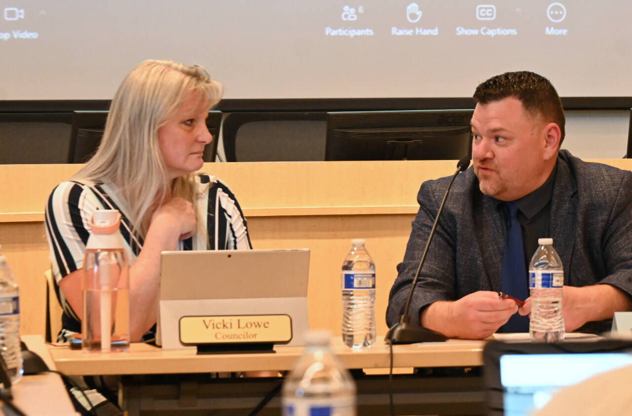 Sequim City Council member Vicki Lowe and Sequim School Board president Eric Pickens talk at a joint meeting at the city council’s chambers on June 25. (Michael Dashiell/Olympic Peninsula News Group)