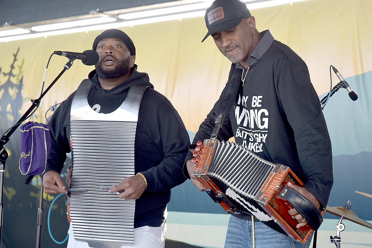 Curley Taylor, frontman for Louisiana-based Curley Taylor and Zydeco Trouble, right, performs with bandmate Matthey Roberts on rubboard during Wednesday night’s Concert on the Pier at Port Angeles City Pier. The free weekly music series, hosted by the Juan de Fuca Foundation and sponsored by Strait View Credit Union, D.A. Davidson & Co., 102.1 FM The Strait and the Peninsula Daily News, continues at 6 p.m. Wednesday with rock and dance band The Nasty Habits. (Keith Thorpe/Peninsula Daily News)
