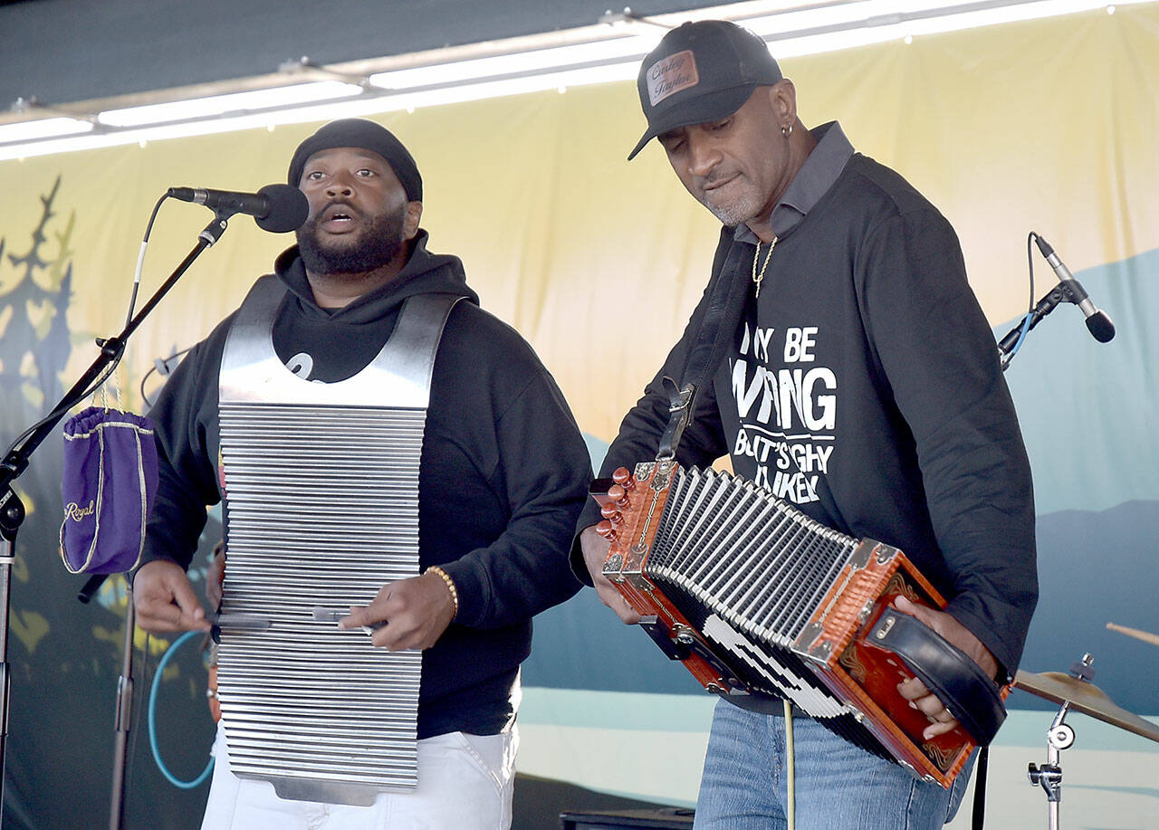 Curley Taylor, frontman for Louisiana-based Curley Taylor and Zydeco Trouble, right, performs with bandmate Matthey Roberts on rubboard during Wednesday night’s Concert on the Pier at Port Angeles City Pier. The free weekly music series, hosted by the Juan de Fuca Foundation and sponsored by Strait View Credit Union, D.A. Davidson & Co., 102.1 FM The Strait and the Peninsula Daily News, continues at 6 p.m. Wednesday with rock and dance band The Nasty Habits. (Keith Thorpe/Peninsula Daily News)