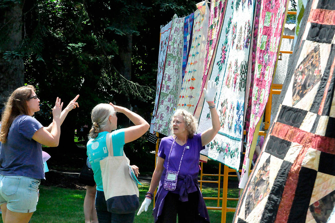 Bernadette Shein helps answer quilt questions for visitors of the Sunbonnet Sue Quilt Club’s annual quilt show in 2023. This year, the event will move to Trinity United Methodist Church and expand to two days, Friday and Saturday. (Matthew Nash/Olympic Peninsula News Group)