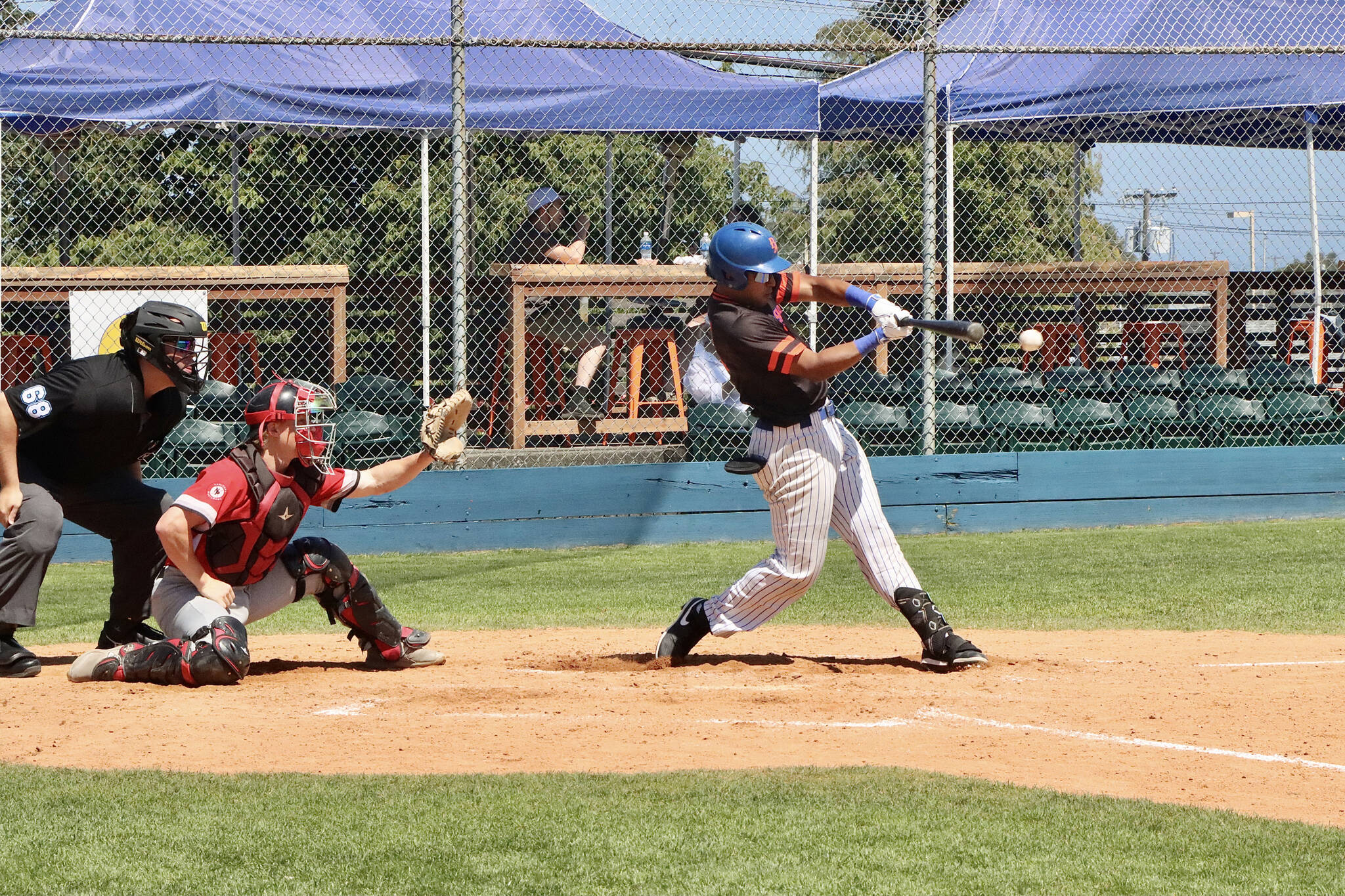Port Angeles’ Roberto Nunez gets the bat on the ball for a single down the left field line in the fourth inning of the Lefties’ game against the Kamloops NorthPaws on Sunday. Port Angeles earned its second walk-off win in as many games. (Dave Logan/for Peninsula Daily News)