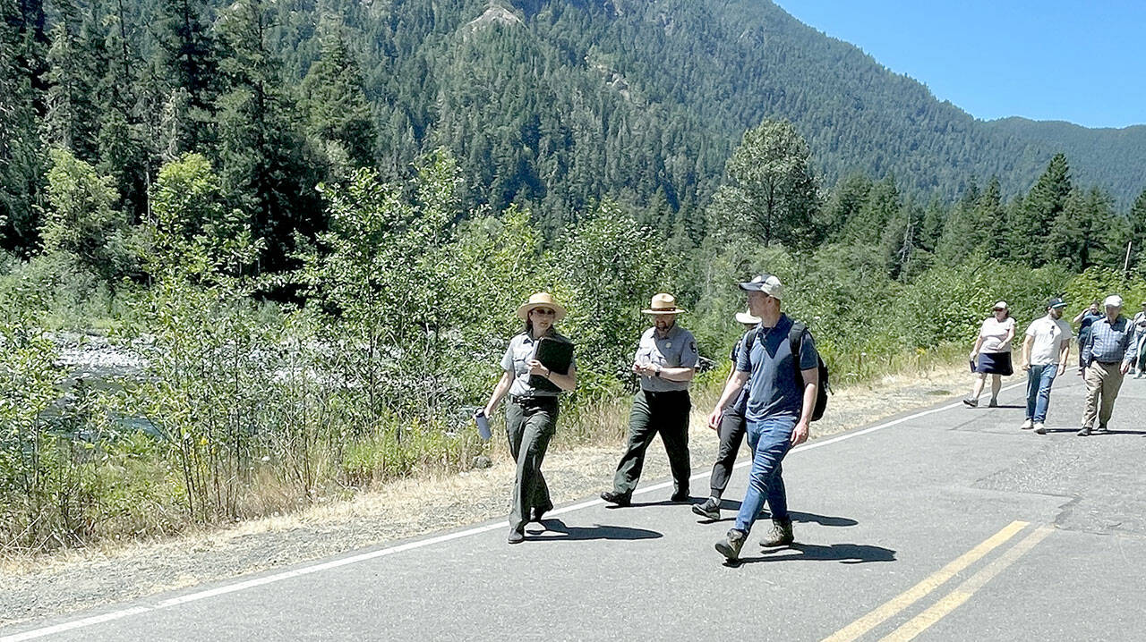 Olympic National Park Superintendent Sula Jacobs, left, and U.S. Rep. Derek Kilmer, D-Gig Harbor, walk on Olympic Hot Springs Road next to the Elwha River about a mile south of Madison Falls on Monday. Kilmer and Rep. Mike Quigley, D-Illinois, led five other U.S. House members on a two-day visit where they met with park scientists to discuss how changes in the climate are impacting national parks. (Paula Hunt/Peninsula Daily News)