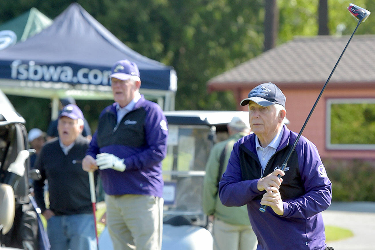 KEITH THORPE/PENINSULA DAILY NEWS
John Raske of Port Angeles, right, tees off on the first hole at the Cedars at Dungeness during Friday's Sonny Sixkiller Celebrity Golf Classic as teammates George Wood, left, and Gary Reidel, both of Port Angeles, watch his drive.