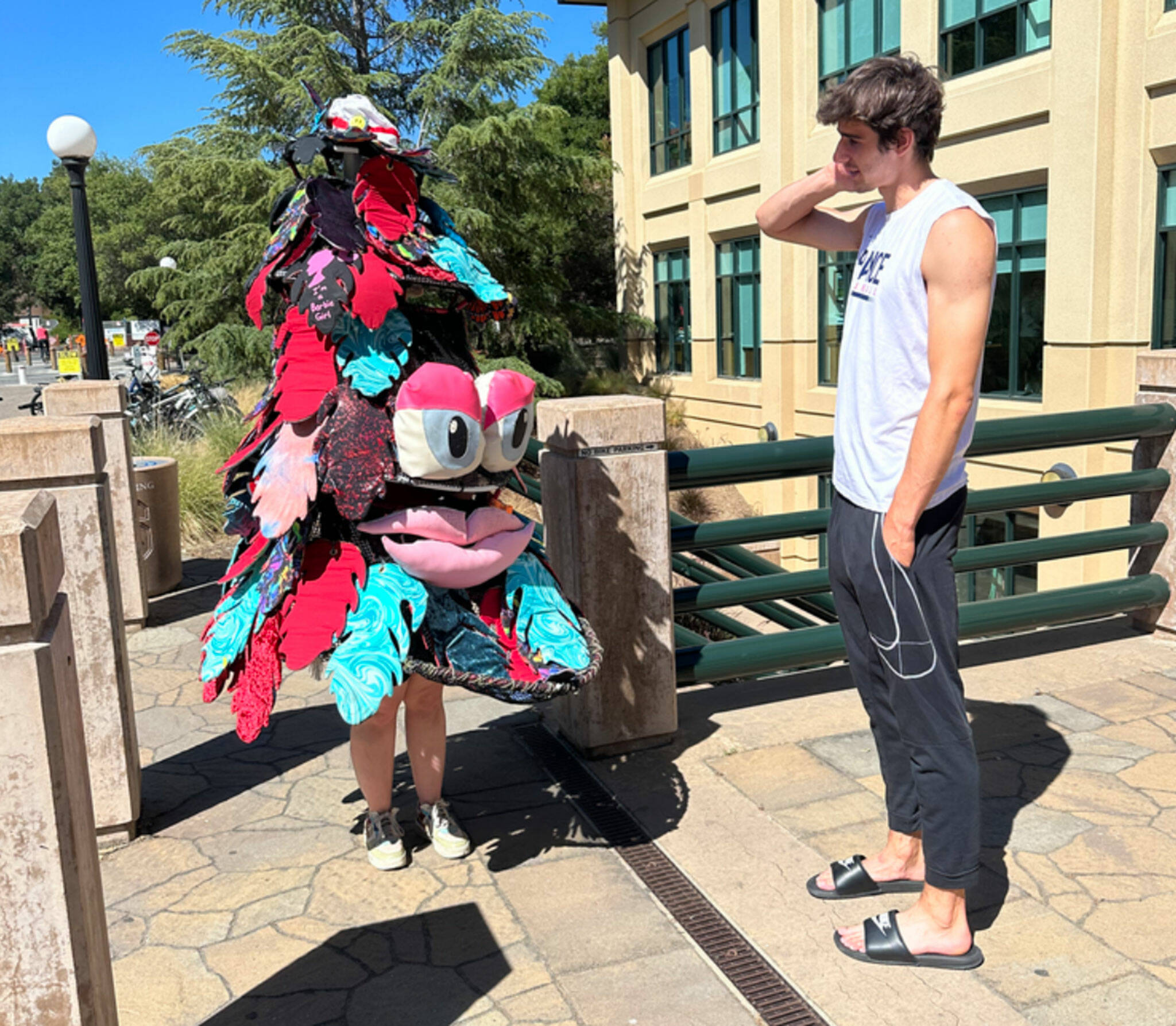 Courtesy Stanford University Athletics (2)
Ruby Coulson of Sequim speaks to Maxime Raynaud, a 7’1” French basketball player on Stanford University’s men’s team, for a promotional video for the college. Coulson is in Paris with a different costume as the Stanford Tree to support Stanford athletes and promote the college at the Paris Olympics.