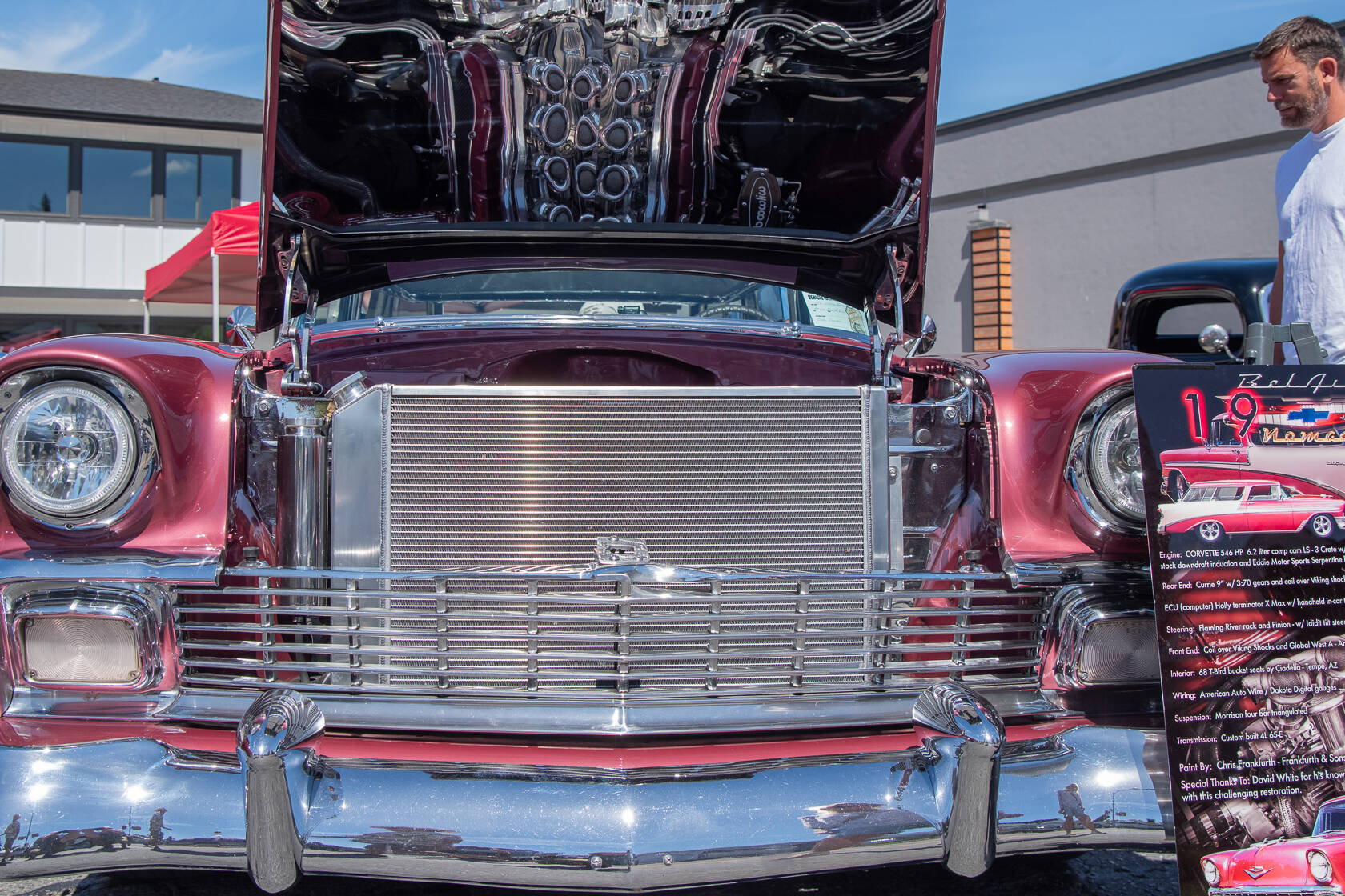 A 1956 Bel Air Nomad attracts passersby with its reflective chrome at the Sequim Prairie Nights Car Show last year. The pattern on the underside of the hood is the reflection of the engine, a Corvette 546 HP. (Emily Matthiessen/Olympic Peninsula News Group)
