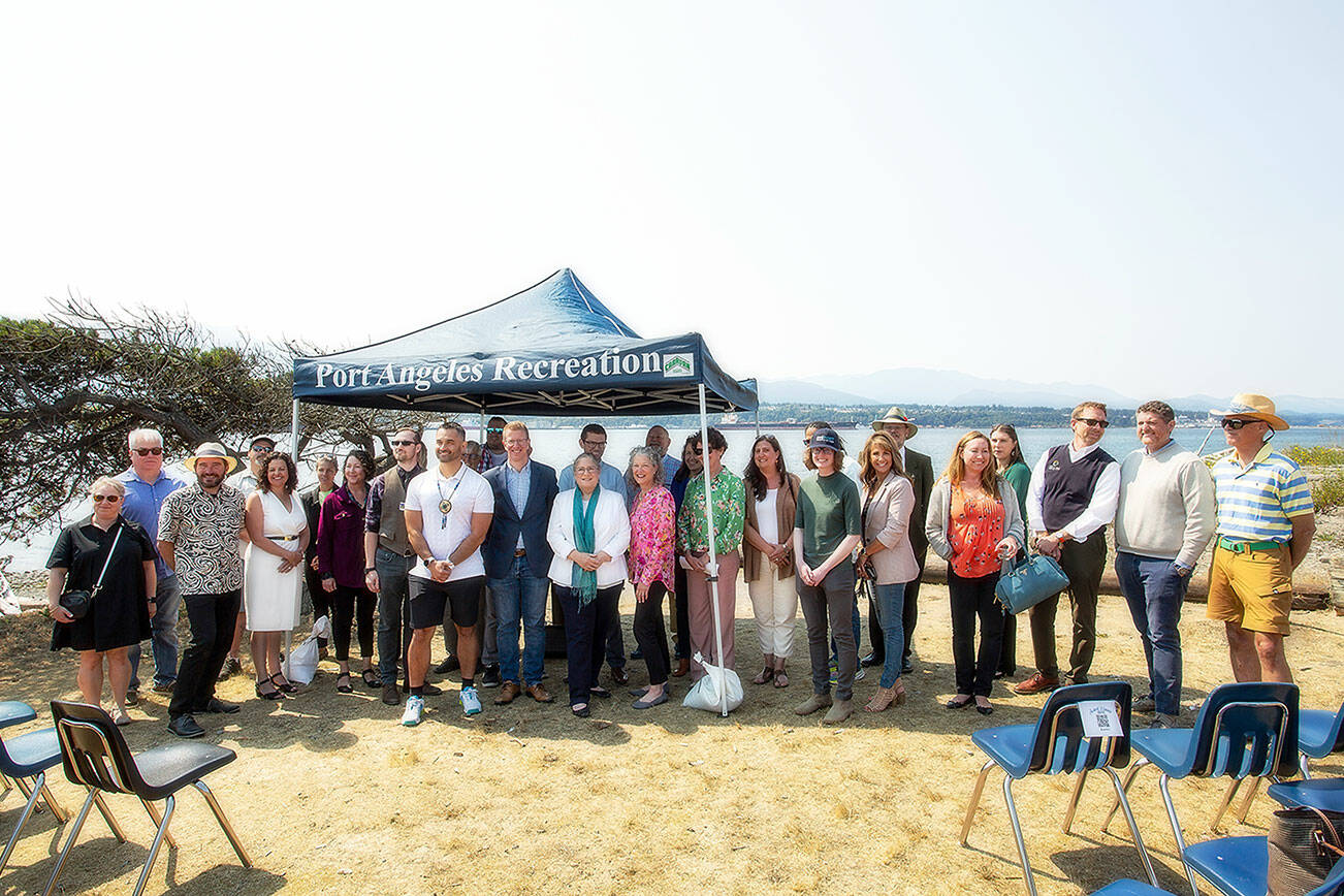 U.S. Rep. Derek Kilmer, D-Gig Harbor, and members of the North Olympic Peninsula Recompete Coalition stand together following a press conference at Harborview Park on Friday in Port Angeles. (Christopher Urquia/Peninsula Daily News)