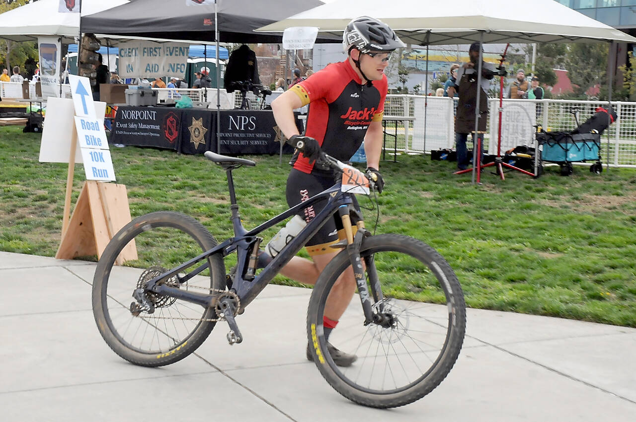 Calvin Colander of Bellingham-based Team Improbability Drive heads for the handoff after finishing the mountain bike leg of the 2023 Big Hurt in Port Angeles. (Keith Thorpe/Peninsula Daily News)