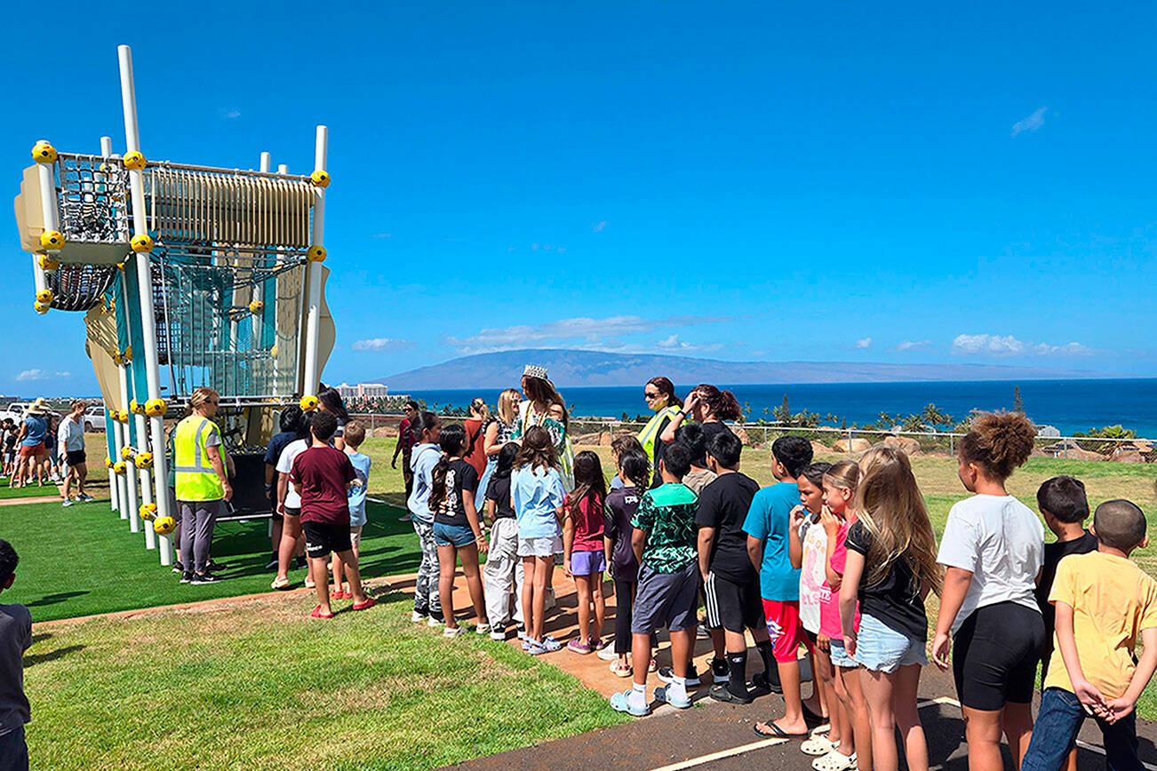 Hawaiian officials, students and staff celebrate the opening of new playground sets at King Kamehameha III Elementary School’s temporary site on Aug. 13. Sequim’s Danielle Patterson helped coordinate and donate the Wagga Wagga structure after wildfires in August 2023 destroyed the school. (Danielle Patterson/Allplay Systems)