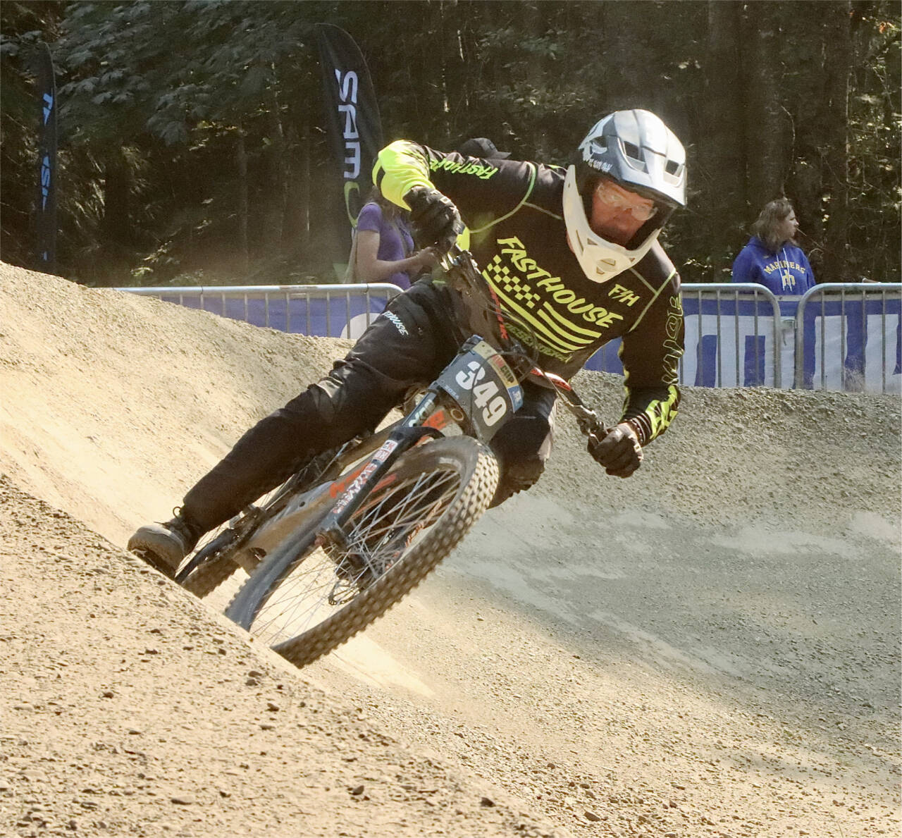Sean Salliotte of Medford, Ore., 52, takes the final banked curve before the finish line at the NW Cup downhill races Sunday. takes the last banked curve before the finish line. (Dave Logan/for Peninsula Daily News)