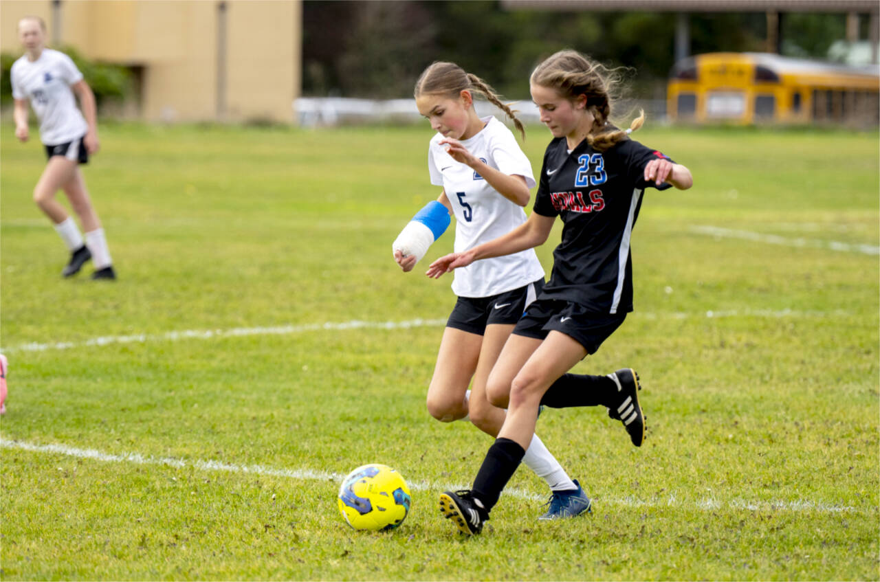 East Jefferson midfielder Olivia McClemans beats Bush's Kate Van Nimwegen to the ball in a nonleague game Saturday in Chimacum. (Steve Mullensky/for Peninsula Daily News)