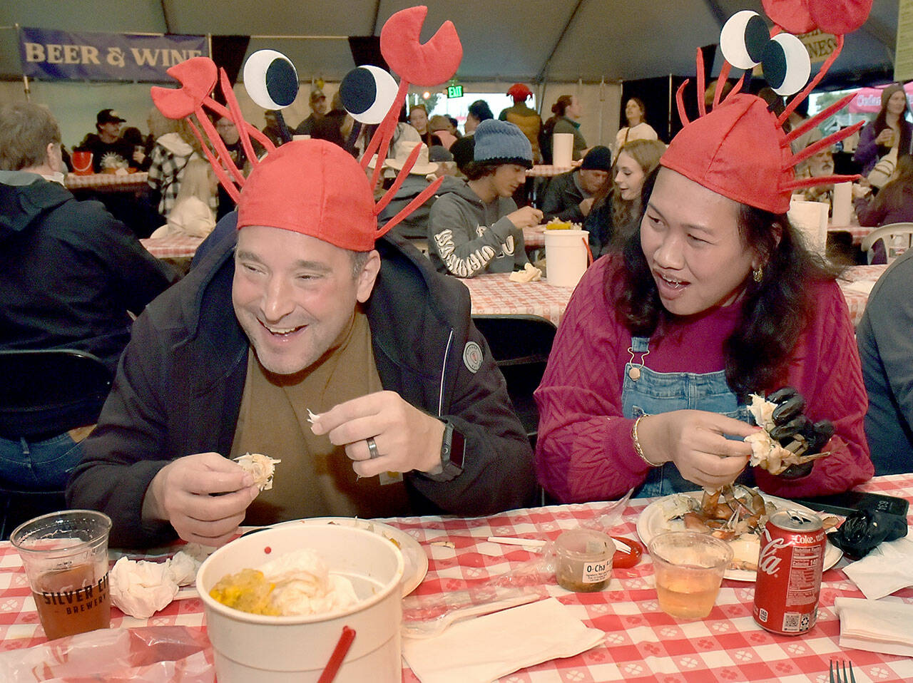 David and Tor Patsiga of University Place enjoy a crab dinner on Saturday during the annual Dungeness Crab Festival in downtown Port Angeles. The three-day event featured a variety of seafoods and other culinary treats, as well as crafts, music and other activities. (Keith Thorpe/Peninsula Daily News)