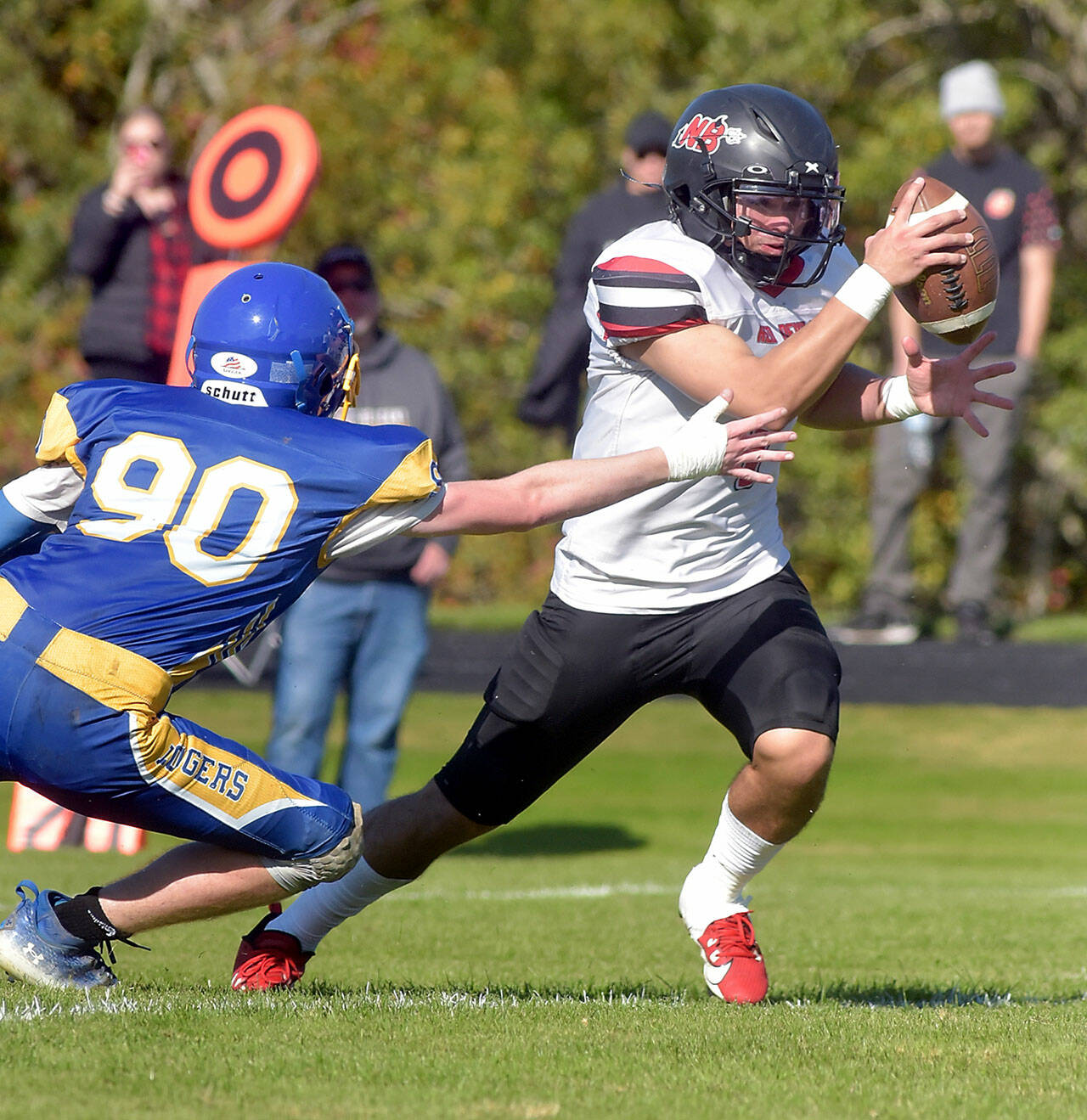 Neah Bay running back Jodell Wimberly evades the tackle of Crescent’s Logan Simons during Saturday’s game in Joyce. (Keith Thorpe/Peninsula Daily News)
