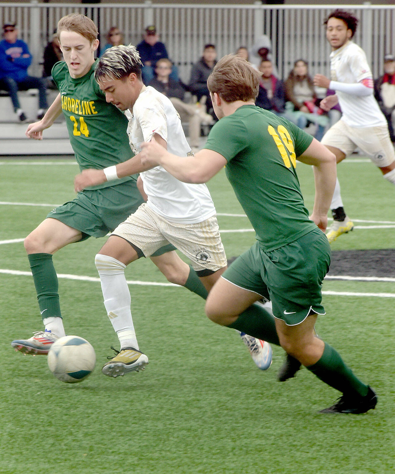 KEITH THORPE/PENINSULA DAILY NEWS Peninsula’s Ezrah Ochoa, center, dribbles downfield accompanied by Shoreline’s Brady Minor, left, and Justin Camacho on Saturday in Port Angeles.