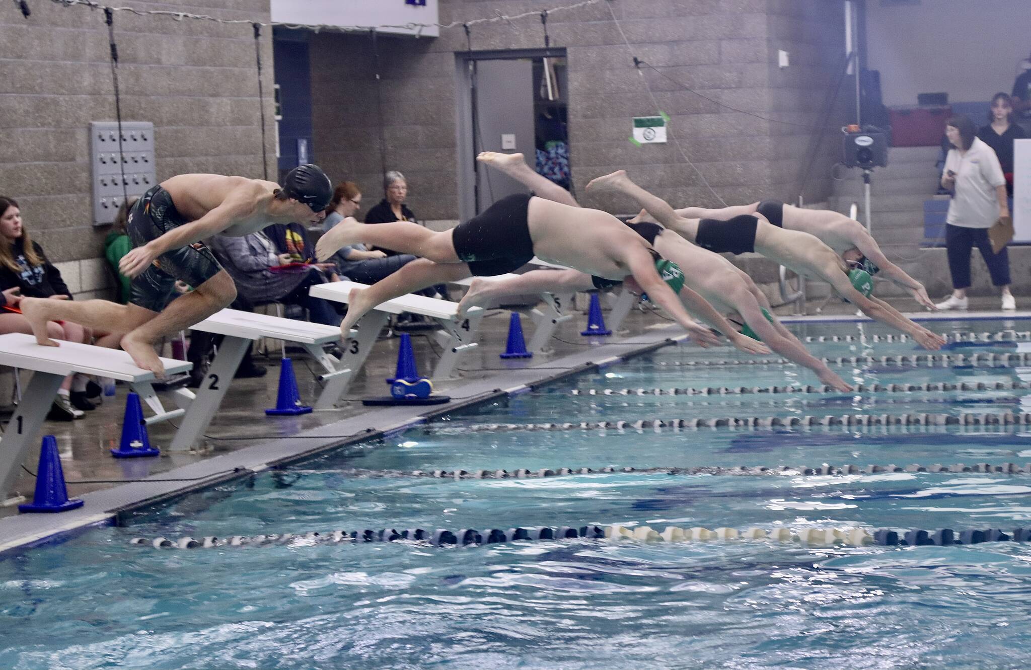 Dave Logan (2)/for Peninsula Daily News
Port Angeles (green caps) and Klahowya swimmers dive into the pool at Shore Aquatic Center for the 200-yard freestyle. The Roughriders won the season-opening Olympic League boys swim meet 147-30 over the Eagles.